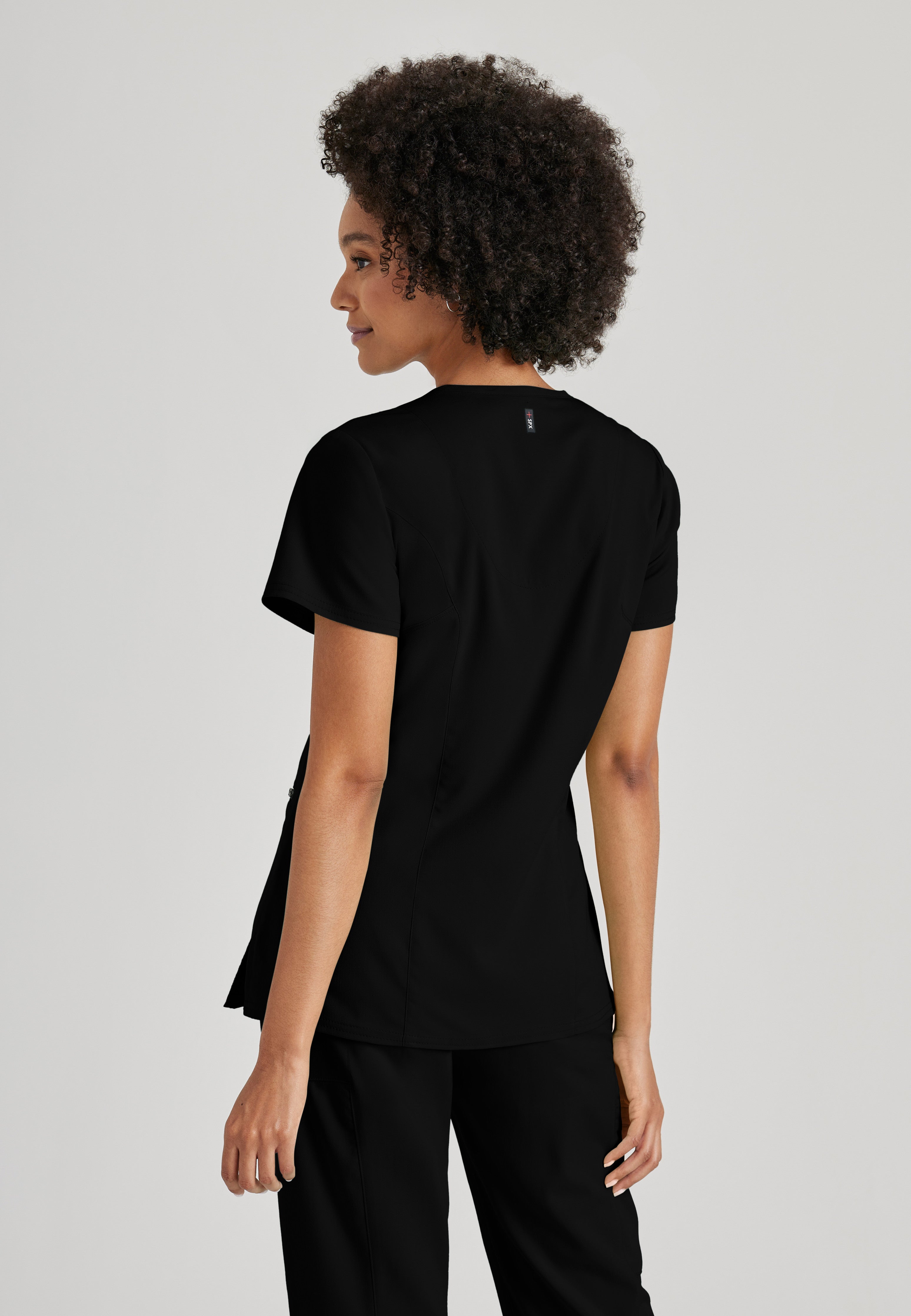 Side View of the Kim 3-Pocket Crossover V-Neck Scrub Top in Black from Grey's Anatomy™ by Barco Spandex Stretch