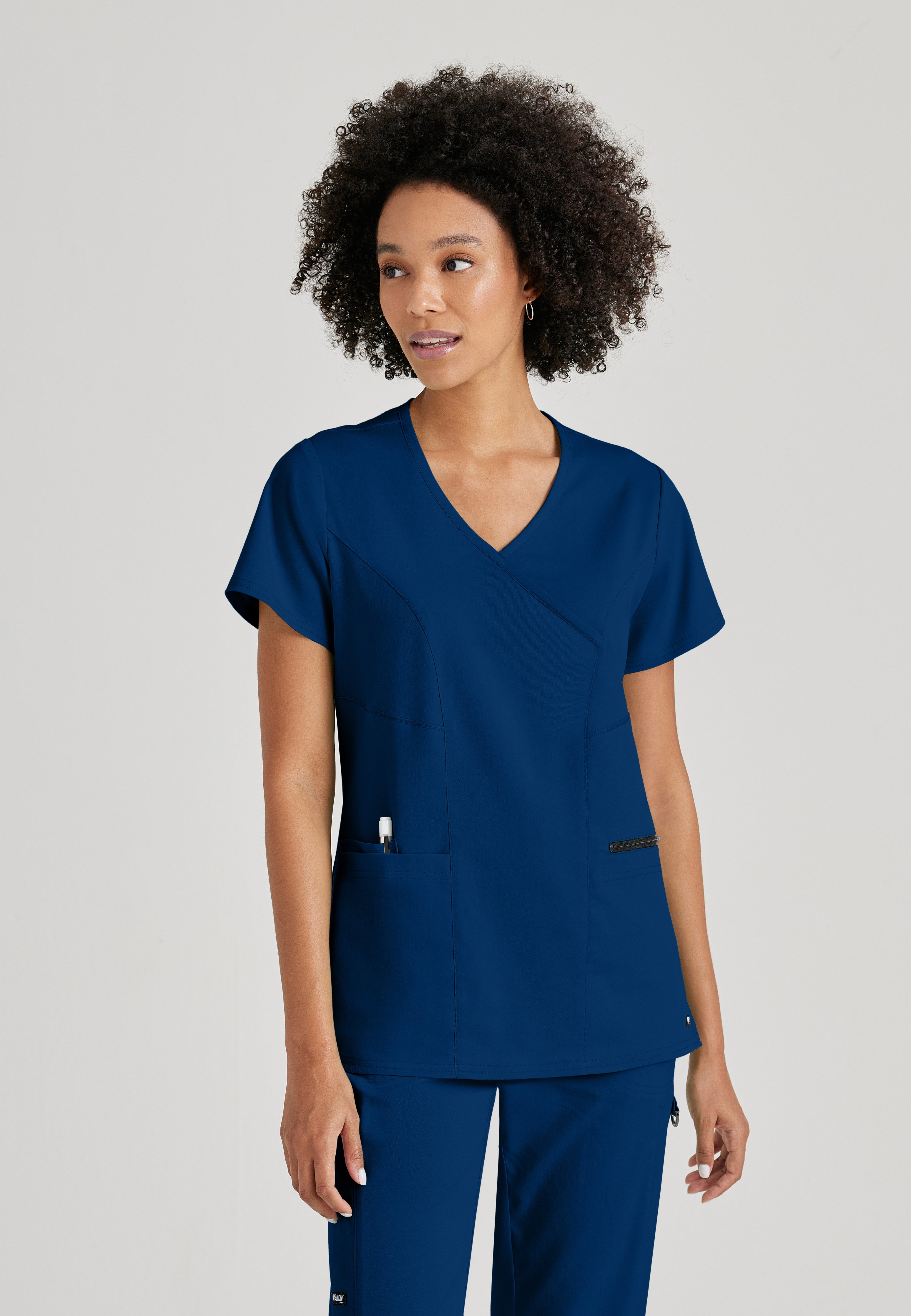 Front View of the Kim 3-Pocket Crossover V-Neck Scrub Top in Indigo from Grey's Anatomy™ by Barco Spandex Stretch