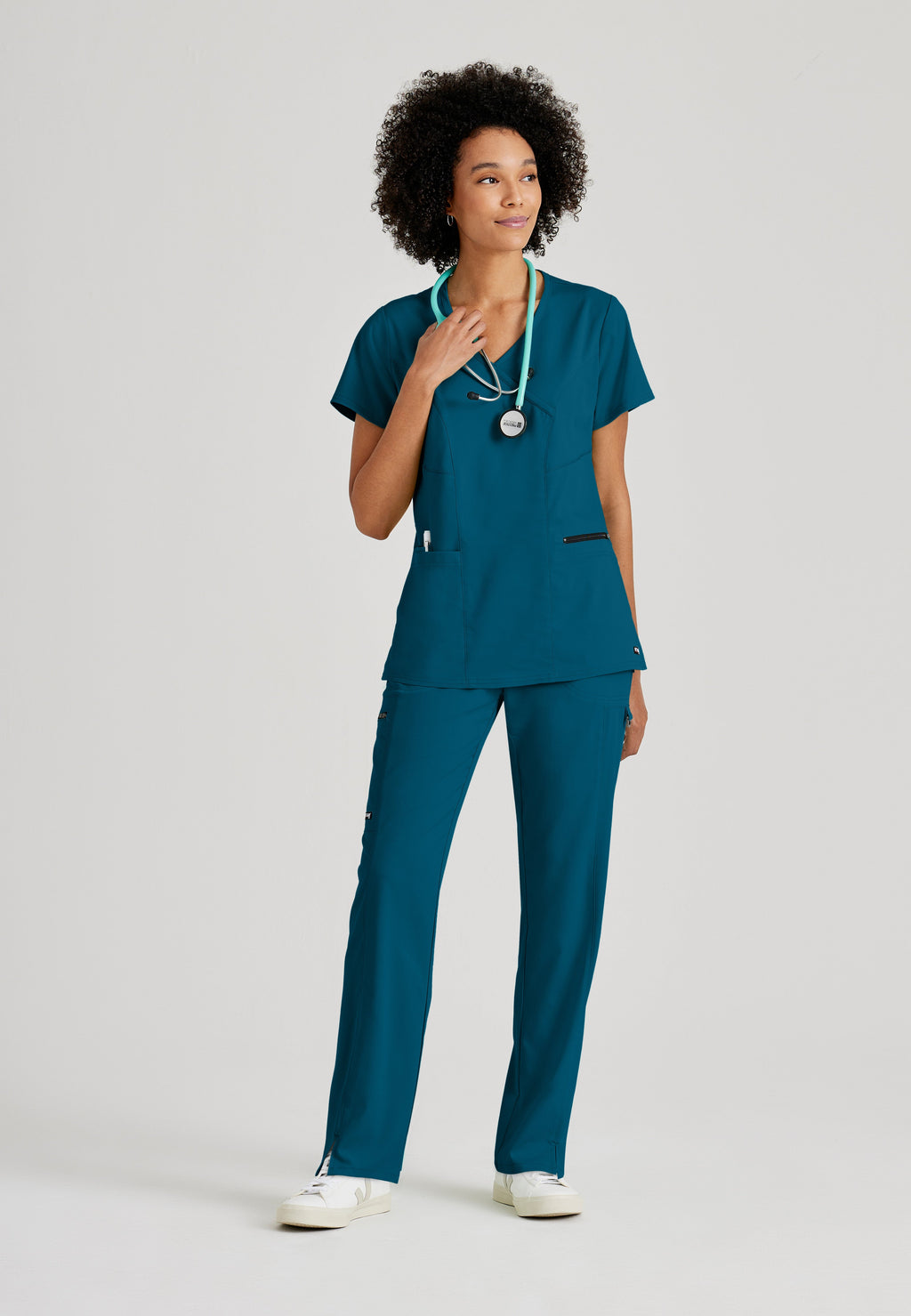 Full Body View of the Kim 3-Pocket Crossover V-Neck Scrub Top in Bahama from Grey's Anatomy™ by Barco Spandex Stretch