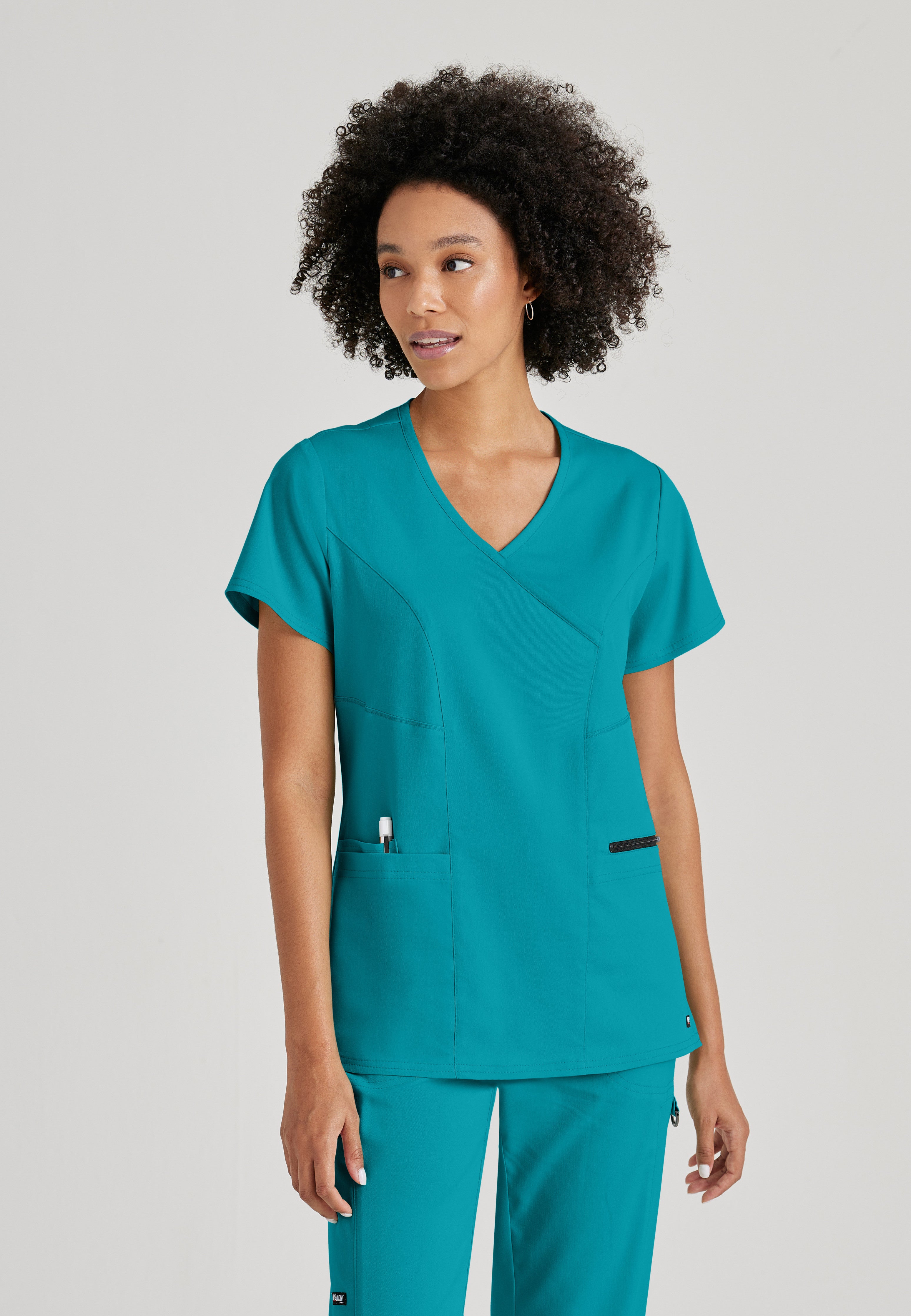 Front View of the Kim 3-Pocket Crossover V-Neck Scrub Top in Teal from Grey's Anatomy™ by Barco Spandex Stretch