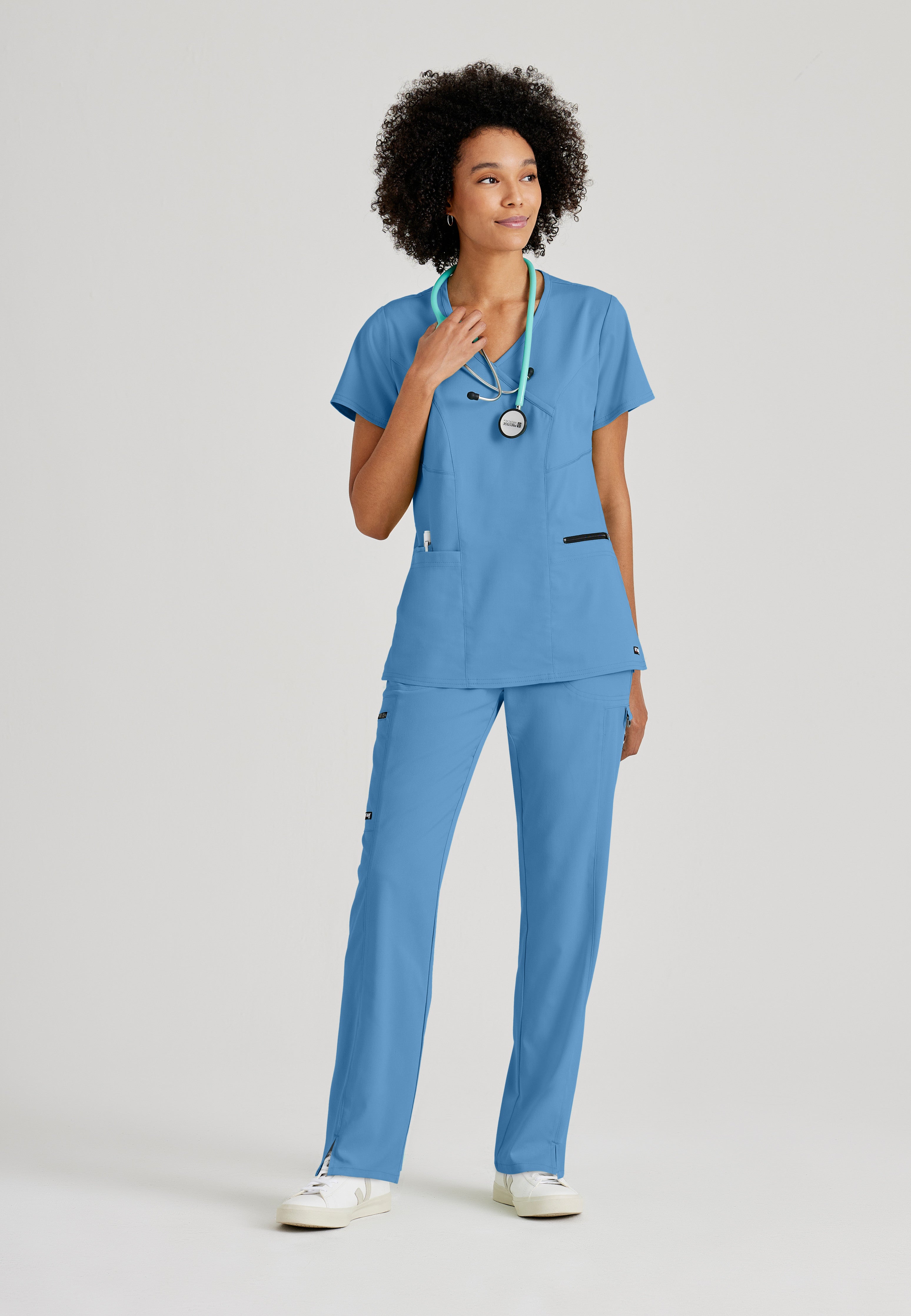 Full Body View of the Kim 3-Pocket Crossover V-Neck Scrub Top in Ciel Blue from Grey's Anatomy™ by Barco Spandex Stretch
