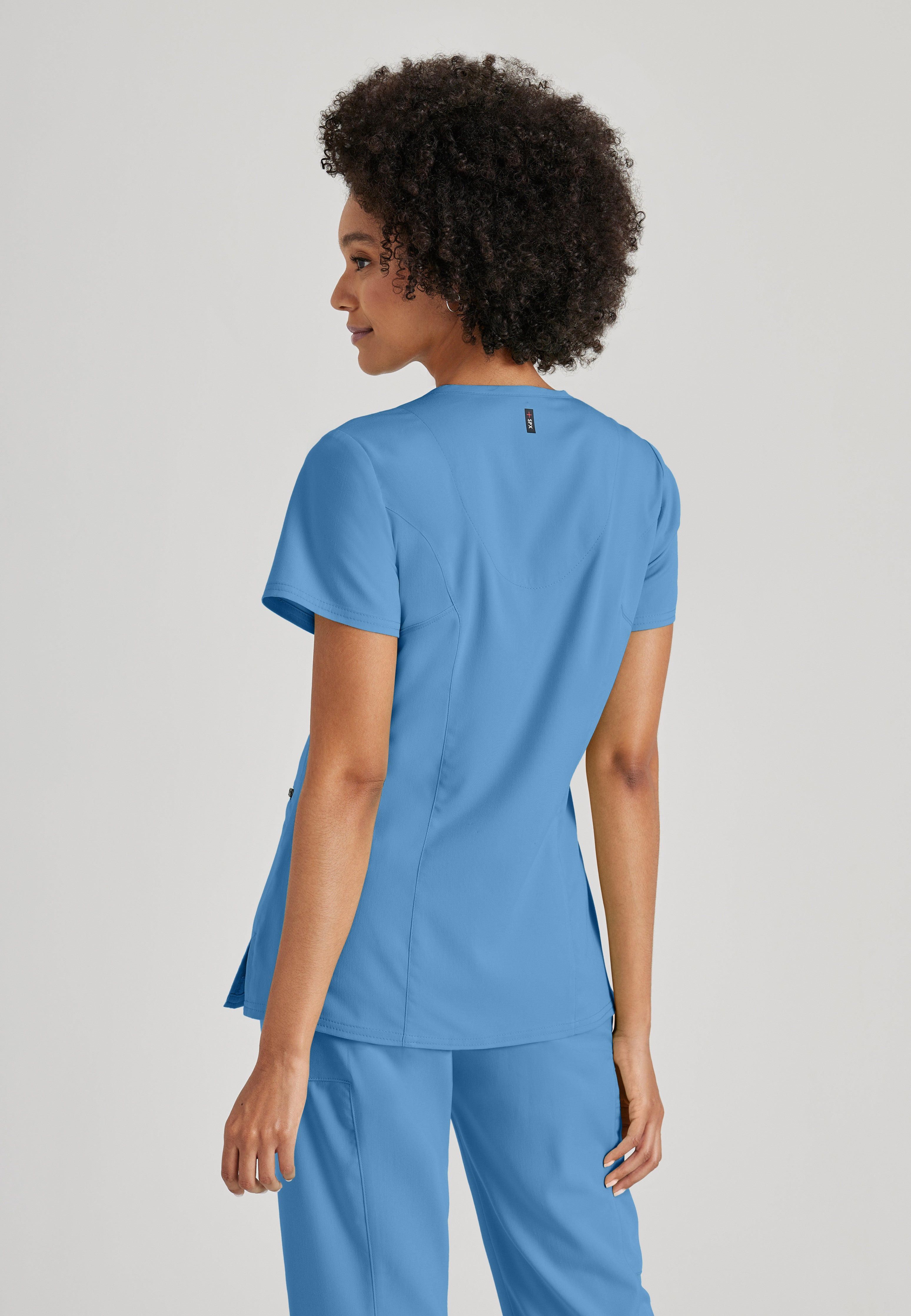Side View of the Kim 3-Pocket Crossover V-Neck Scrub Top in Ciel Blue from Grey's Anatomy™ by Barco Spandex Stretch