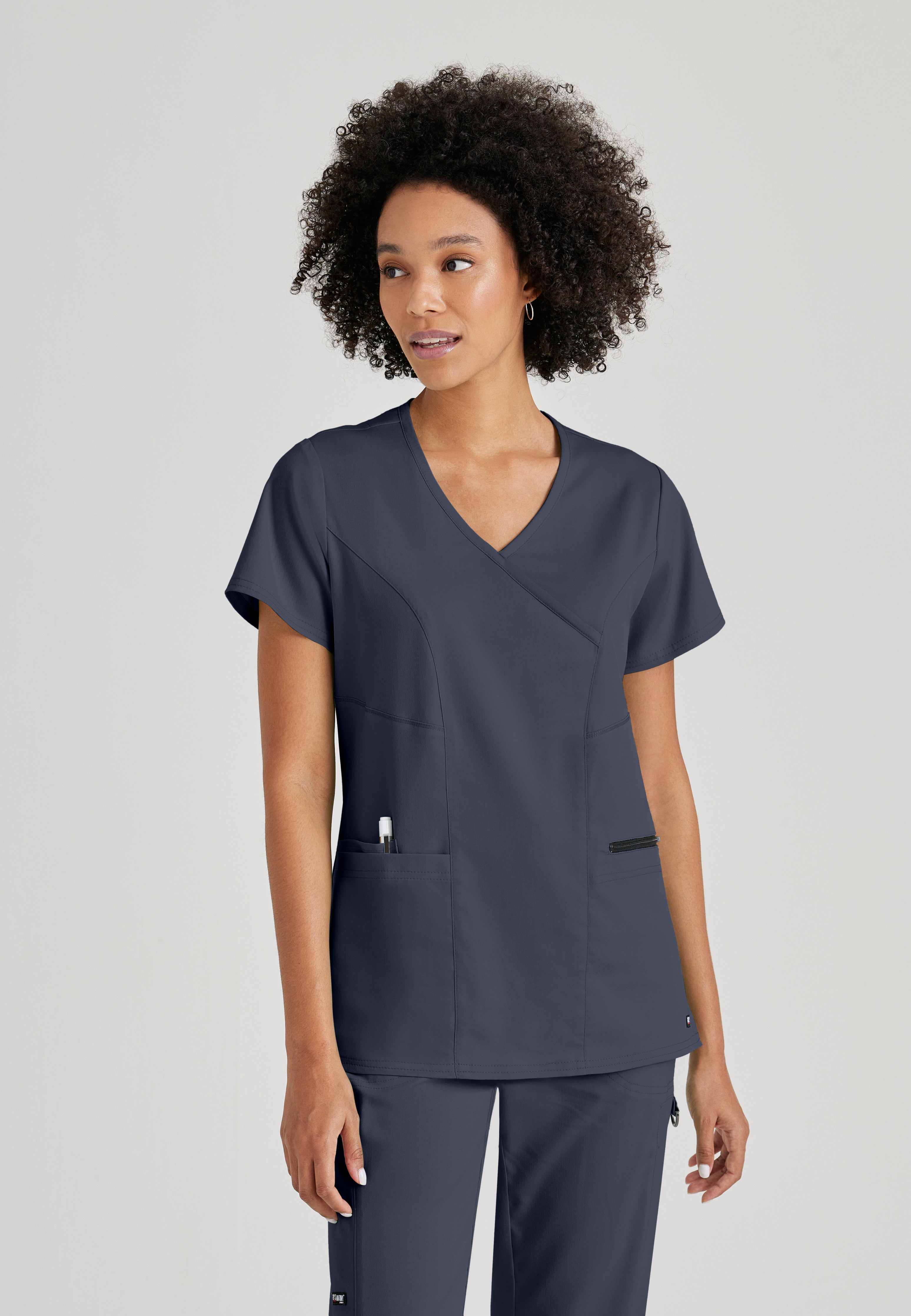 Front View of the Kim 3-Pocket Crossover V-Neck Scrub Top in Steel from Grey's Anatomy™ by Barco Spandex Stretch