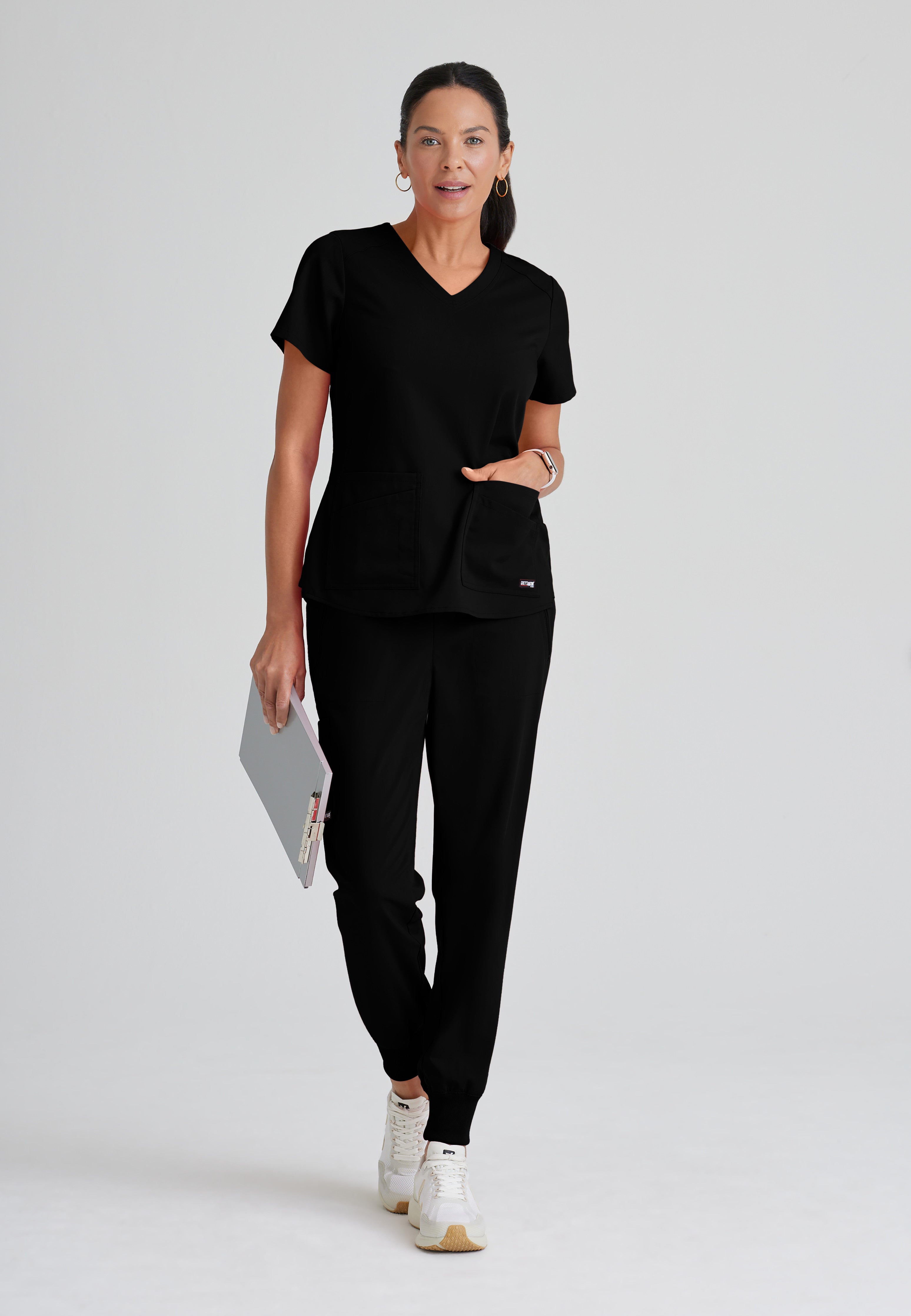 Full Body View of the Emma 4-Pocket V-Neck Scrub Top in Black from Grey's Anatomy™ by Barco Spandex Stretch