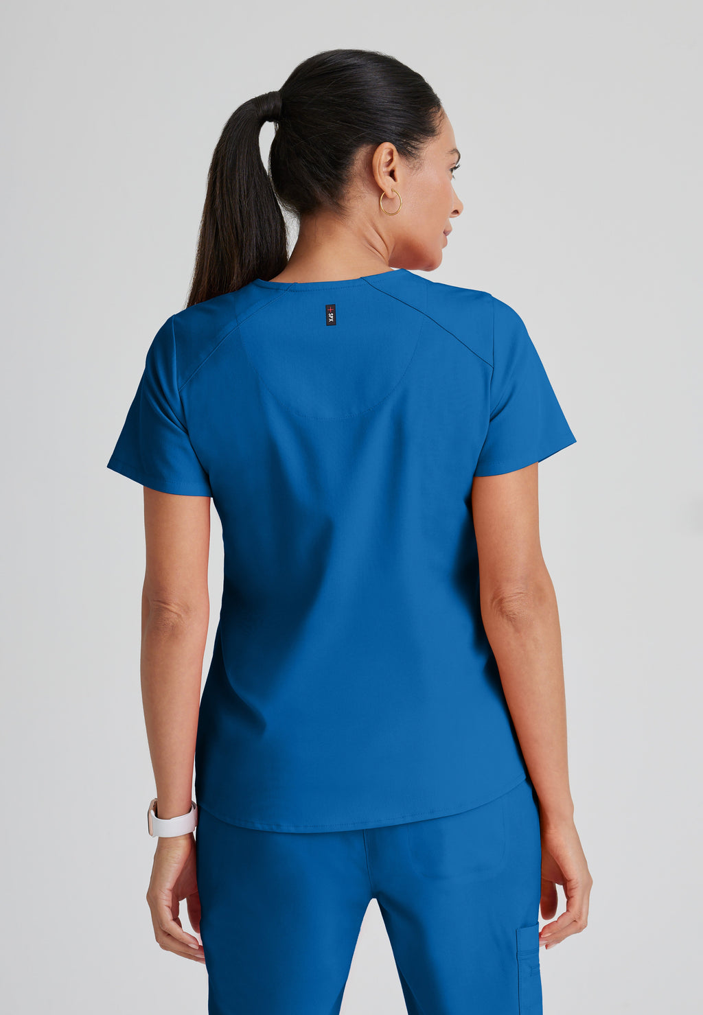 Back View of the Emma 4-Pocket V-Neck Scrub Top in New Royal from Grey's Anatomy™ by Barco Spandex Stretch
