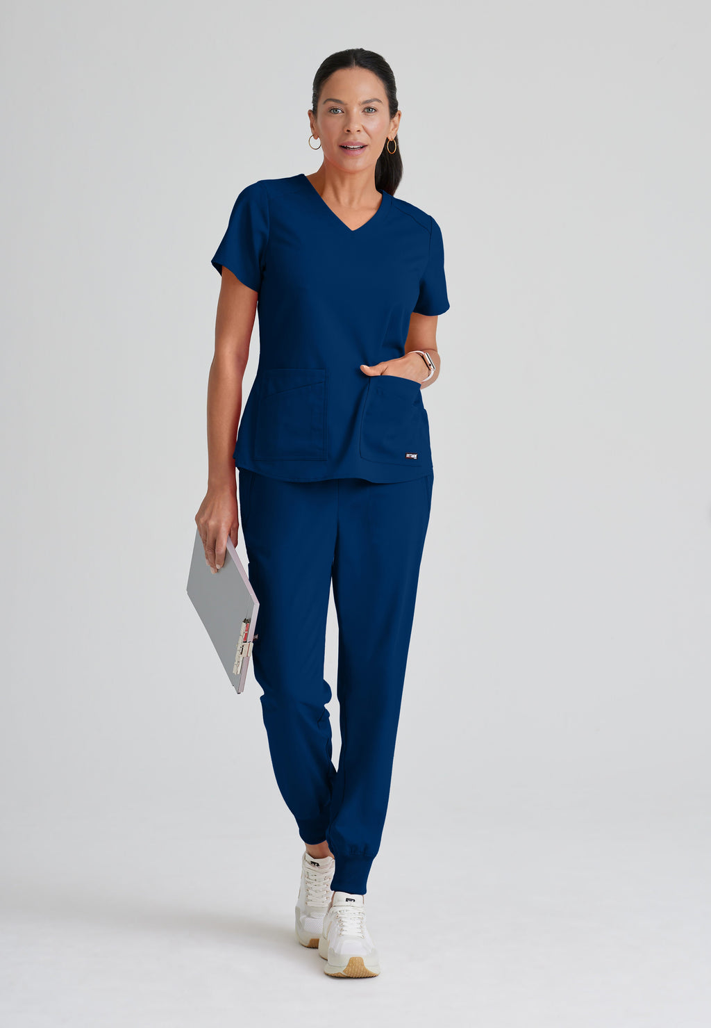 Full Body View of the Emma 4-Pocket V-Neck Scrub Top in Indigo from Grey's Anatomy™ by Barco Spandex Stretch