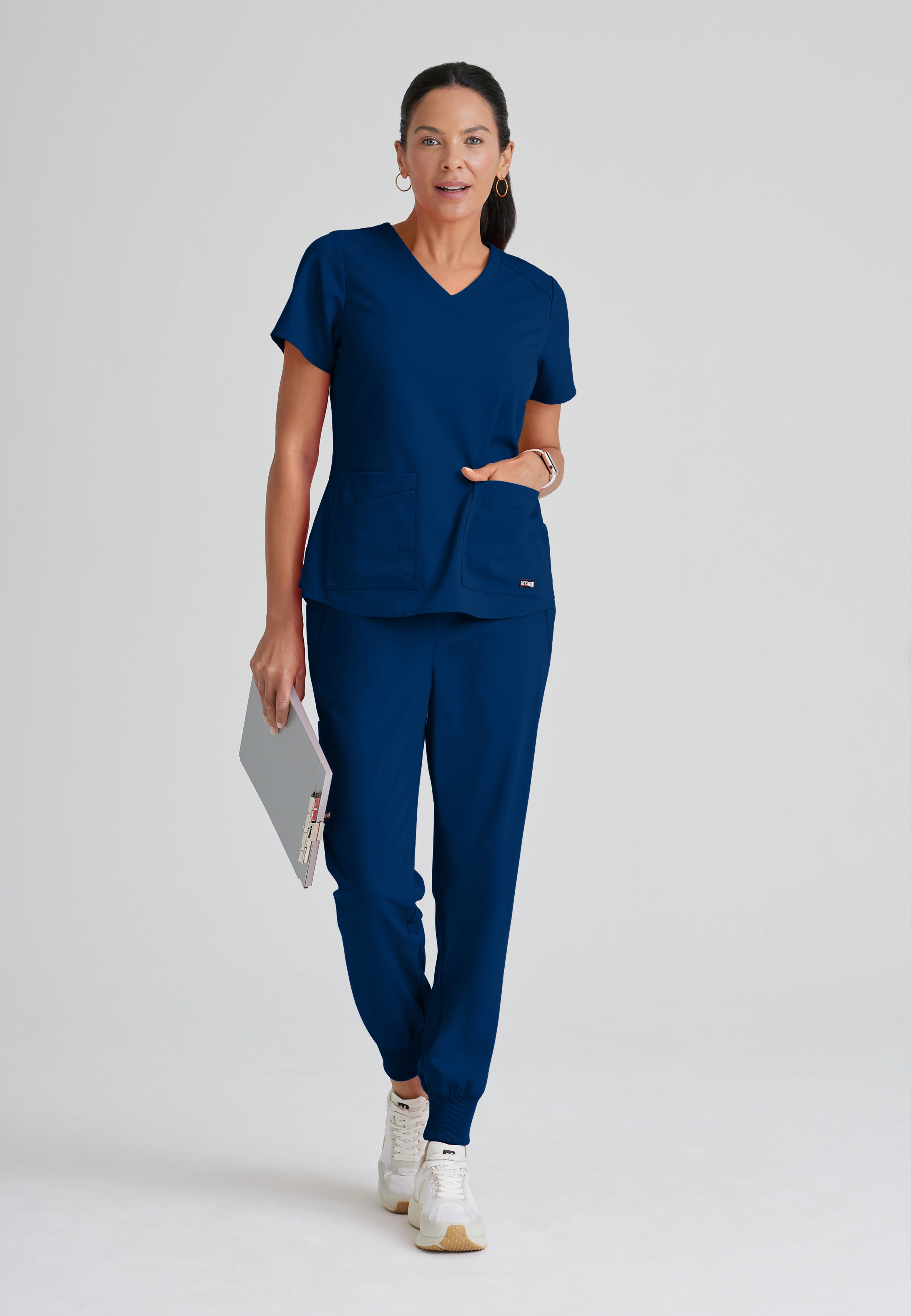 Full Body View of the Emma 4-Pocket V-Neck Scrub Top in Indigo from Grey's Anatomy™ by Barco Spandex Stretch