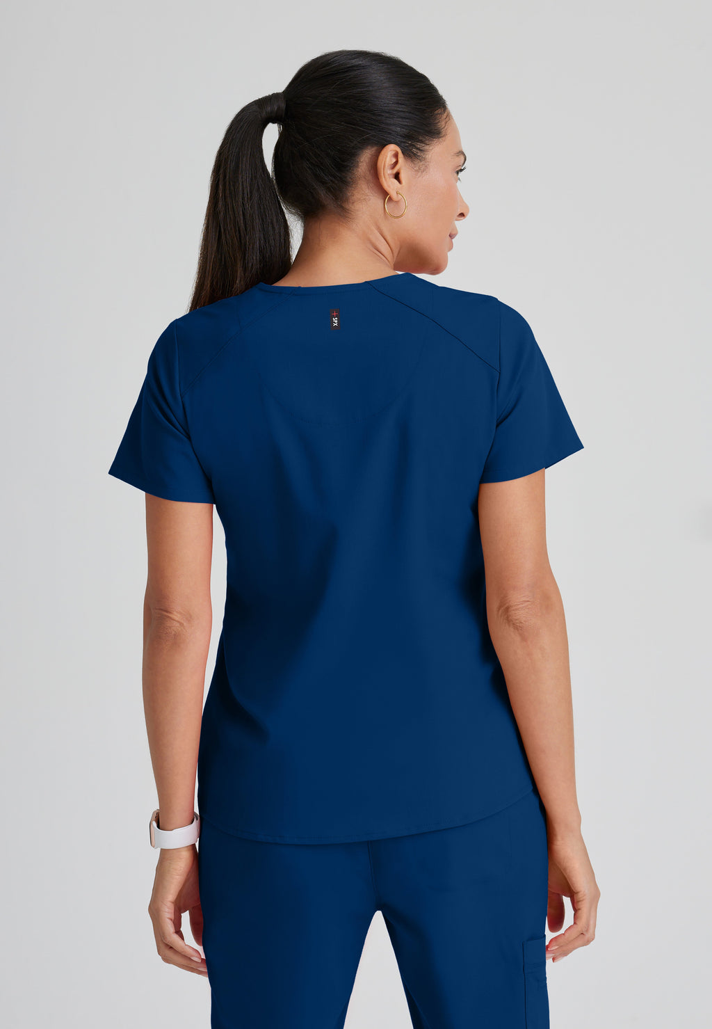 Back View of the Emma 4-Pocket V-Neck Scrub Top in Indigo from Grey's Anatomy™ by Barco Spandex Stretch