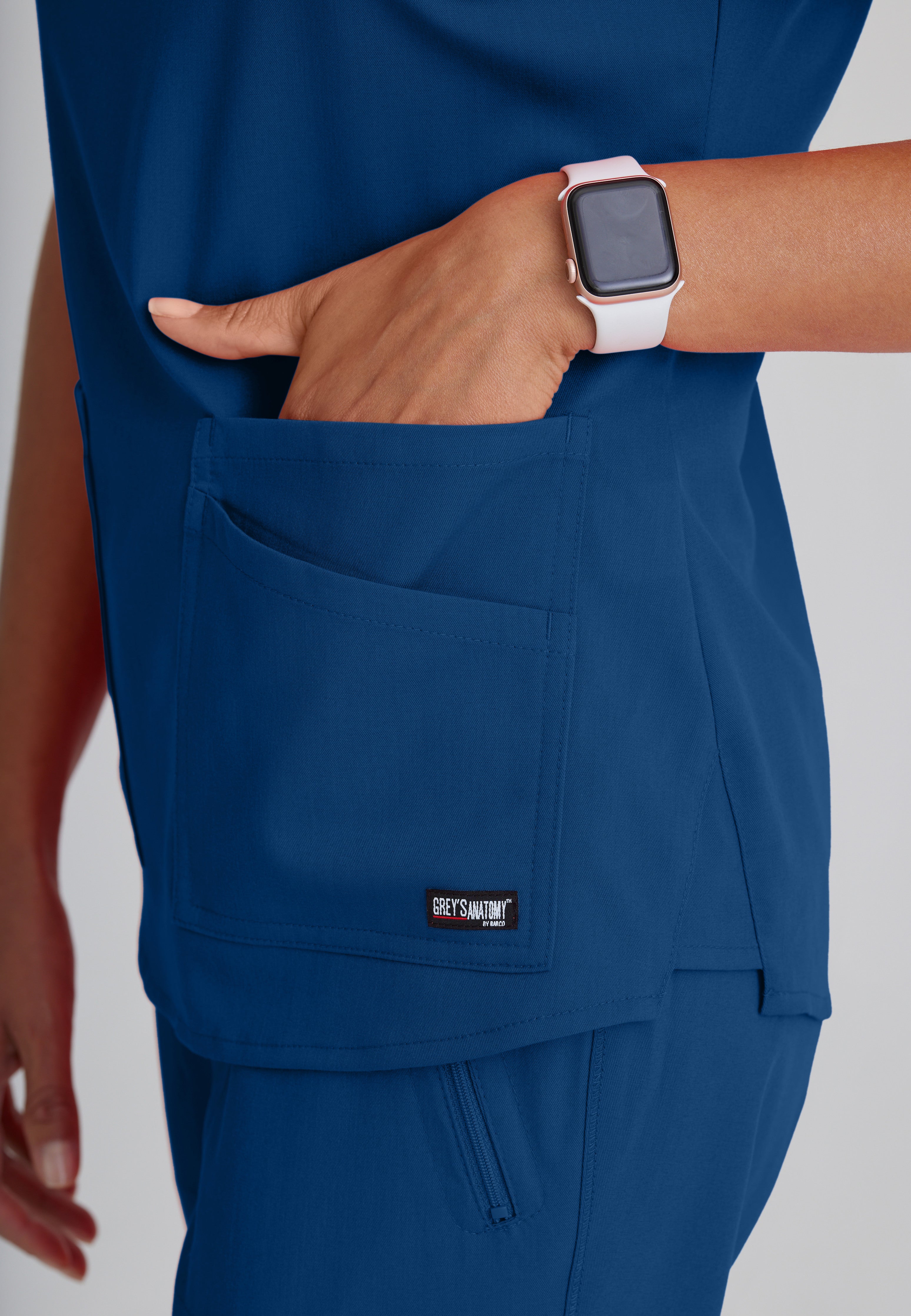 Detail Shot of the Emma 4-Pocket V-Neck Scrub Top in Indigo from Grey's Anatomy™ by Barco Spandex Stretch