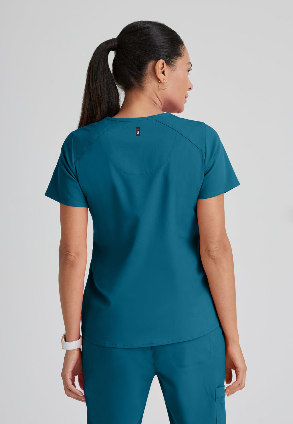Back View of the Emma 4-Pocket V-Neck Scrub Top in Bahama from Grey's Anatomy™ by Barco Spandex Stretch