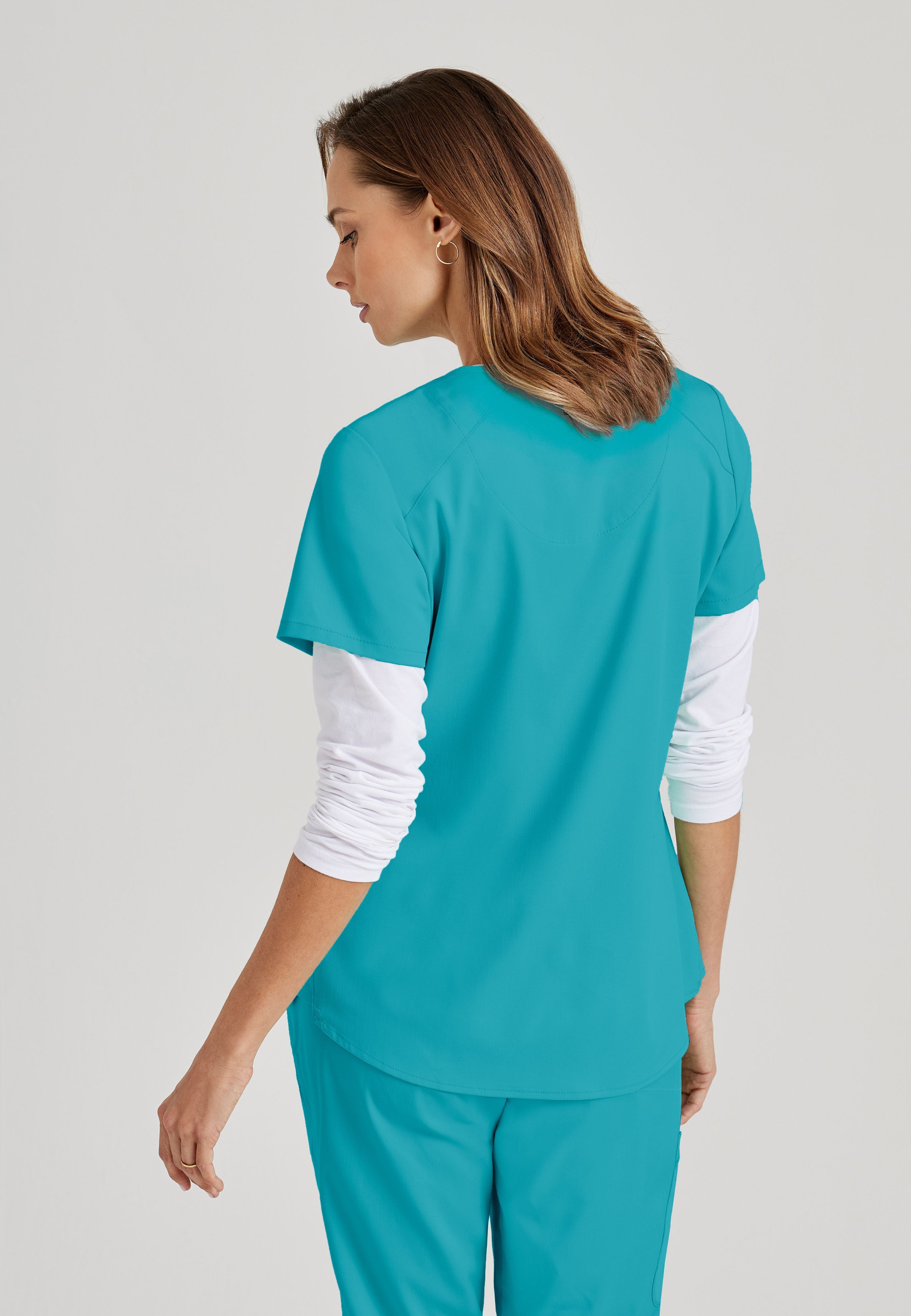 Grey's Anatomy Spandex-Stretch women's teal scrub top. V-neck. 4 pockets. Soft touch. Moisture-wicking stretch fabric.