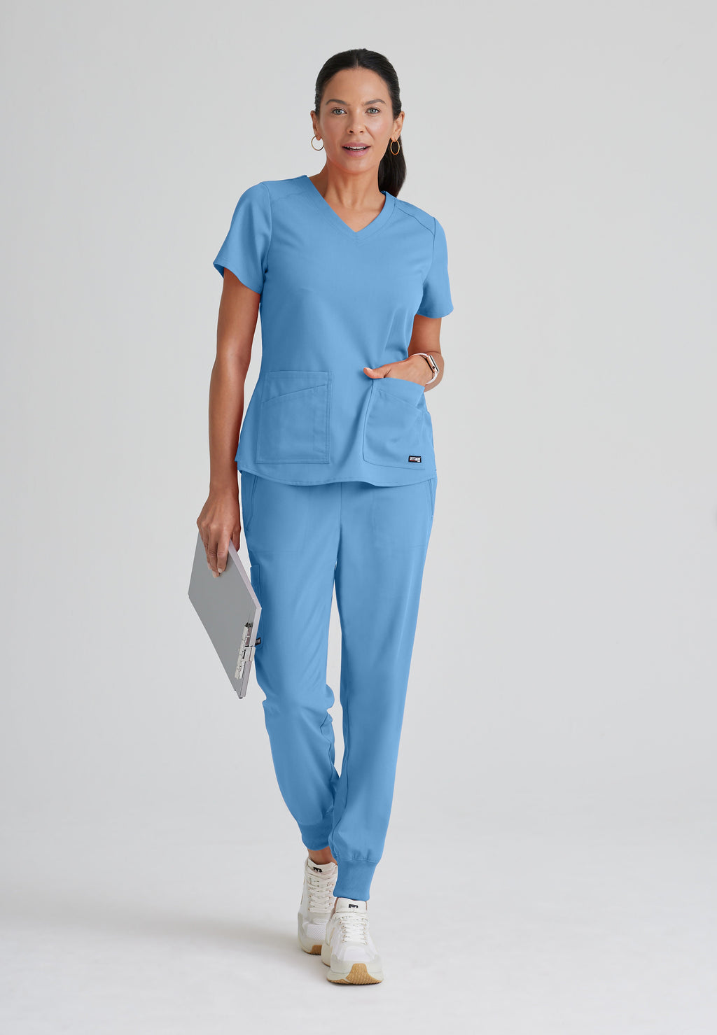 Full Body View of the Emma 4-Pocket V-Neck Scrub Top in Ciel Blue from Grey's Anatomy™ by Barco Spandex Stretch