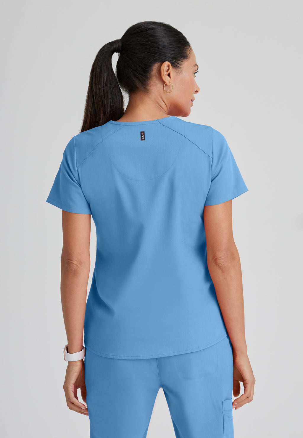 Back View of the Emma 4-Pocket V-Neck Scrub Top in Ciel Blue from Grey's Anatomy™ by Barco Spandex Stretch