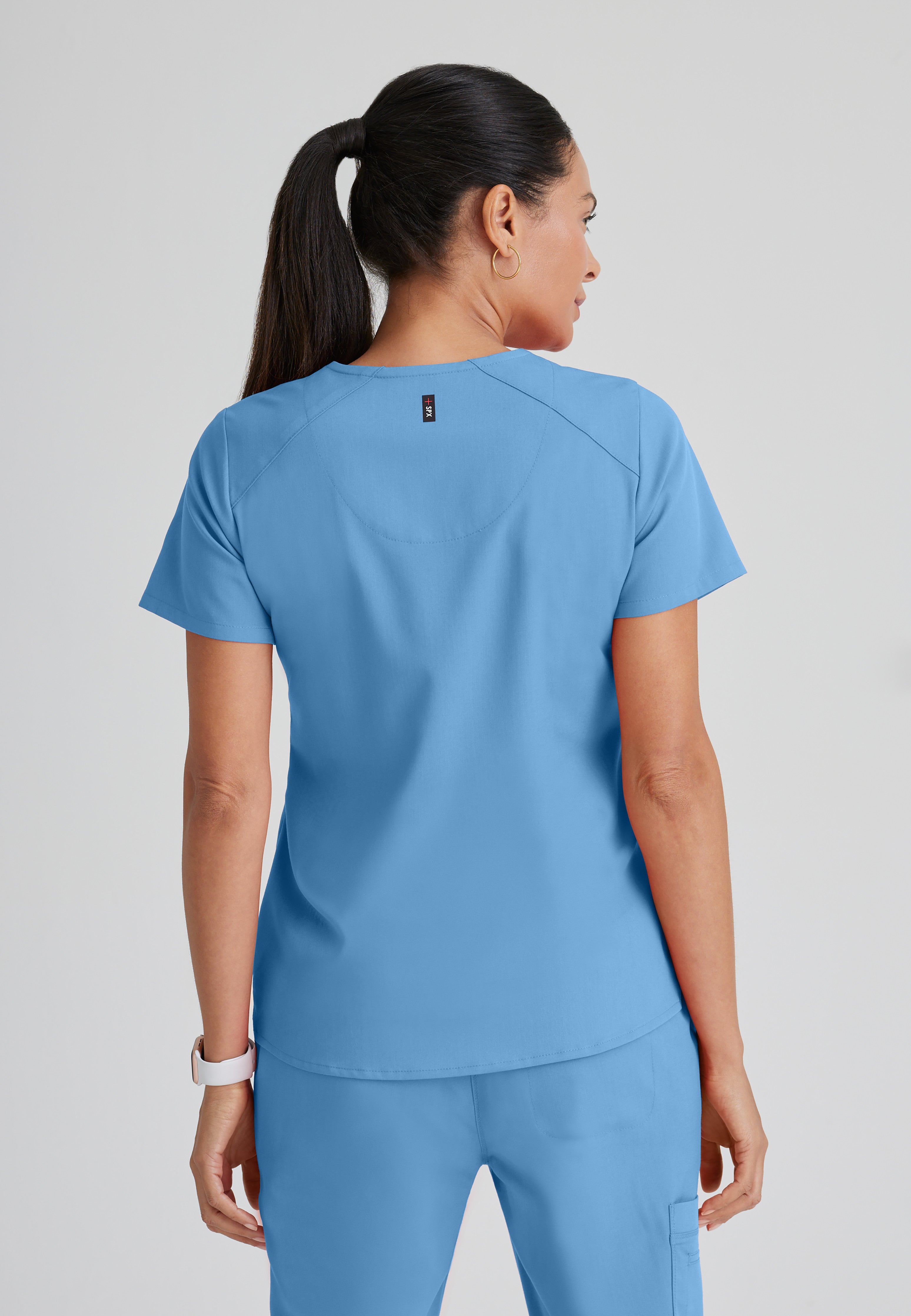 Back View of the Emma 4-Pocket V-Neck Scrub Top in Ciel Blue from Grey's Anatomy™ by Barco Spandex Stretch