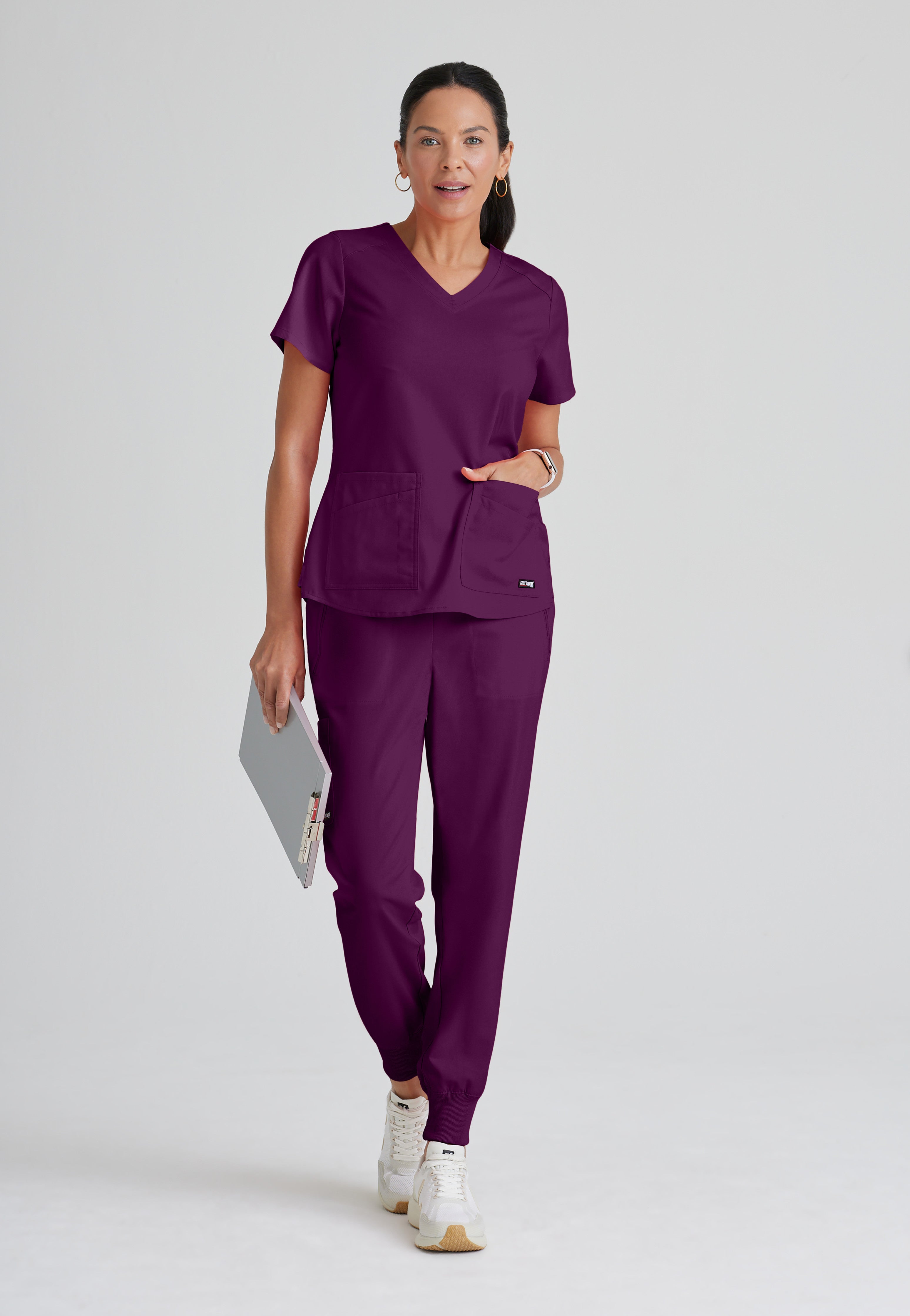 Full Body View of the Emma 4-Pocket V-Neck Scrub Top in Wine from Grey's Anatomy™ by Barco Spandex Stretch