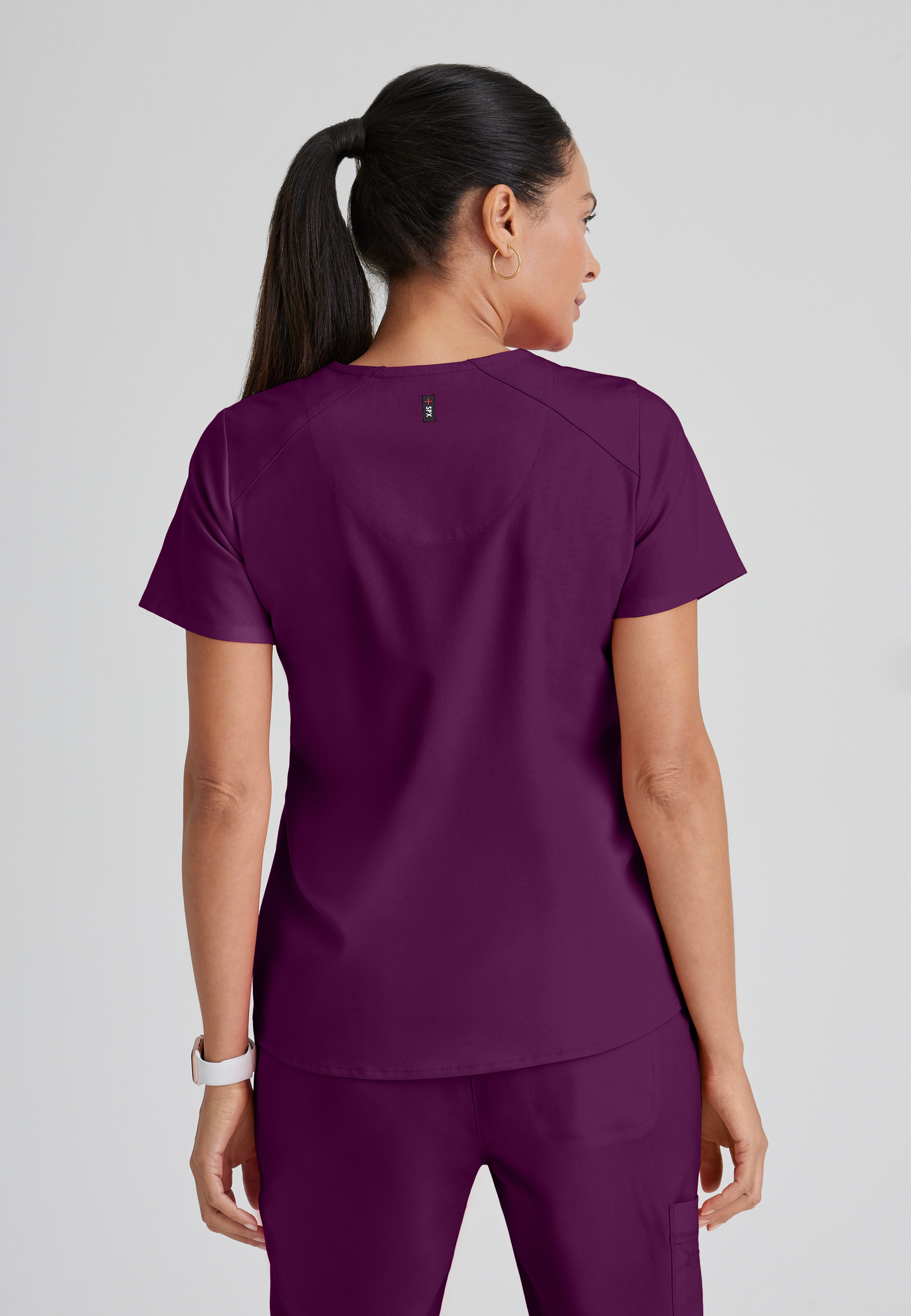 Back View of the Emma 4-Pocket V-Neck Scrub Top in Wine from Grey's Anatomy™ by Barco Spandex Stretch