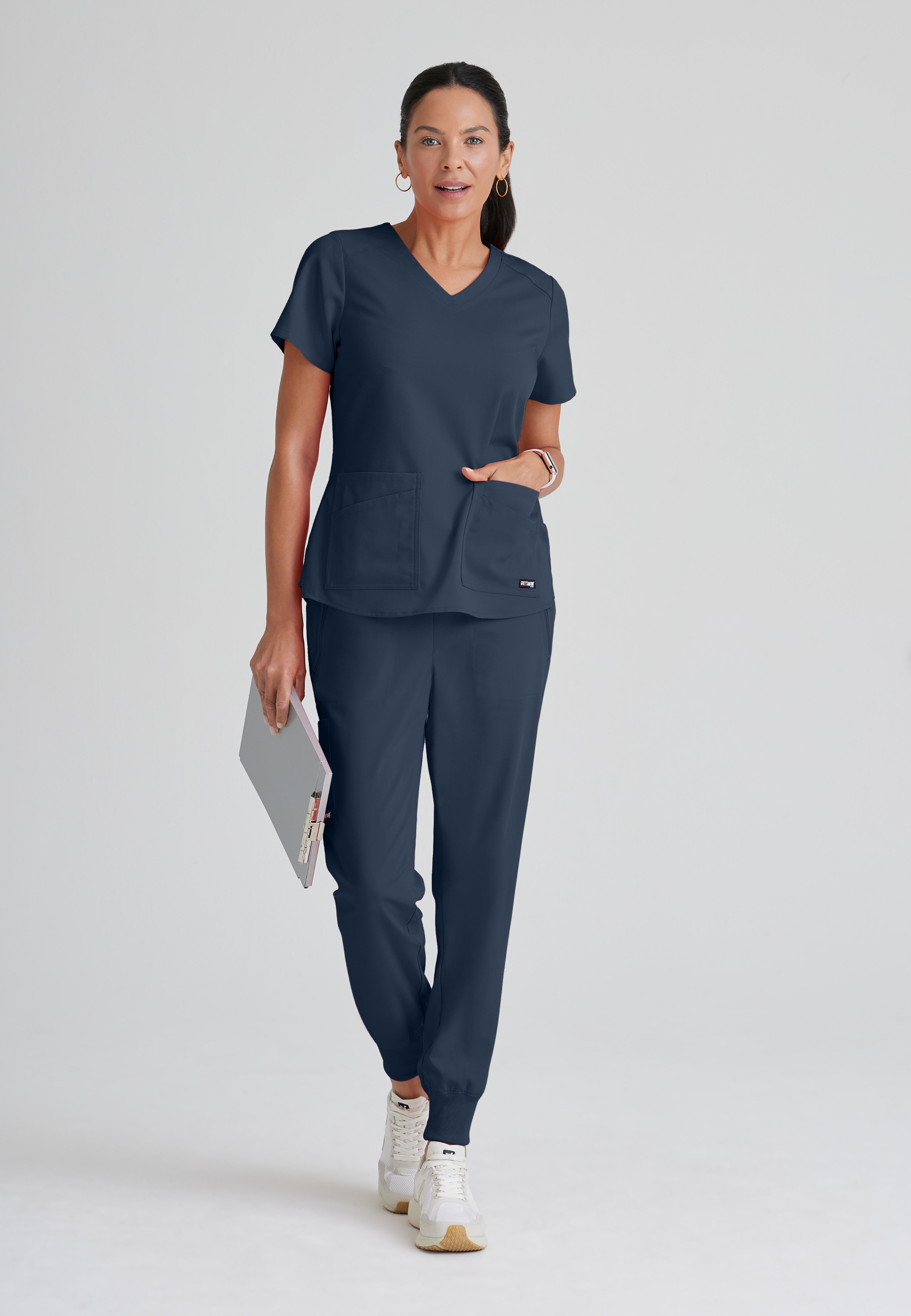 Full Body View of the Emma 4-Pocket V-Neck Scrub Top in Steel from Grey's Anatomy™ by Barco Spandex Stretch