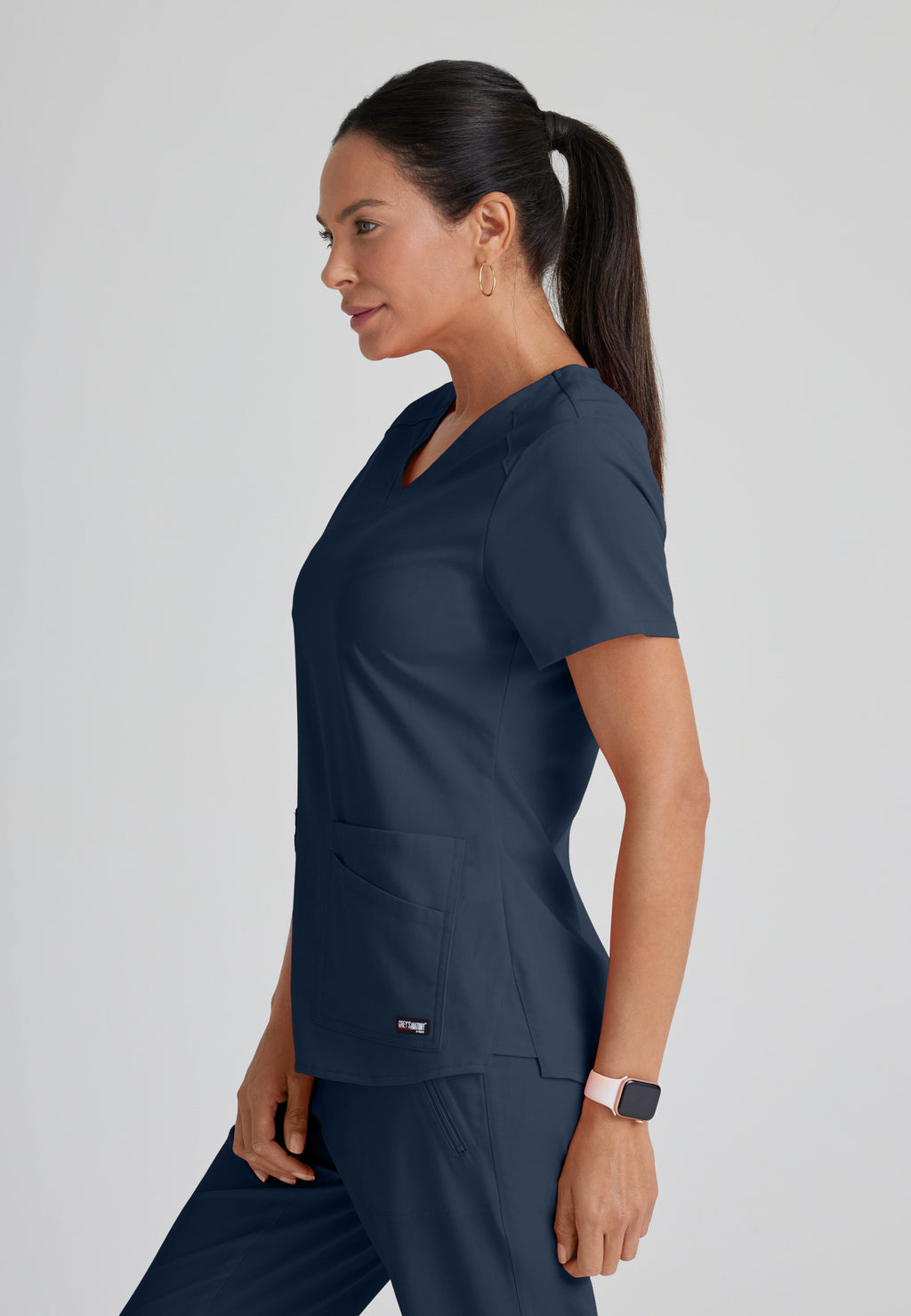 Side View of the Emma 4-Pocket V-Neck Scrub Top in Steel from Grey's Anatomy™ by Barco Spandex Stretch