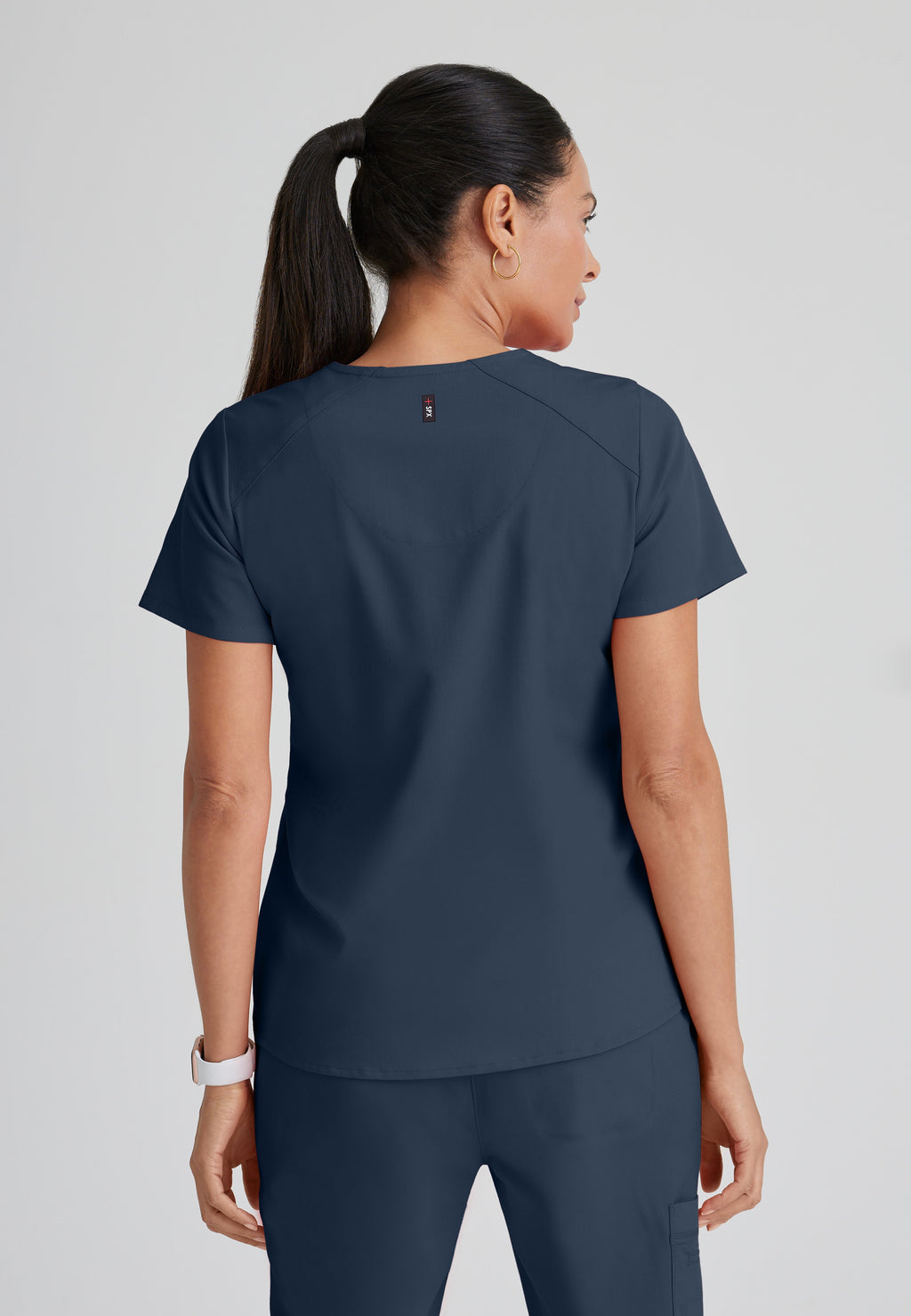 Back View of the Emma 4-Pocket V-Neck Scrub Top in Steel from Grey's Anatomy™ by Barco Spandex Stretch