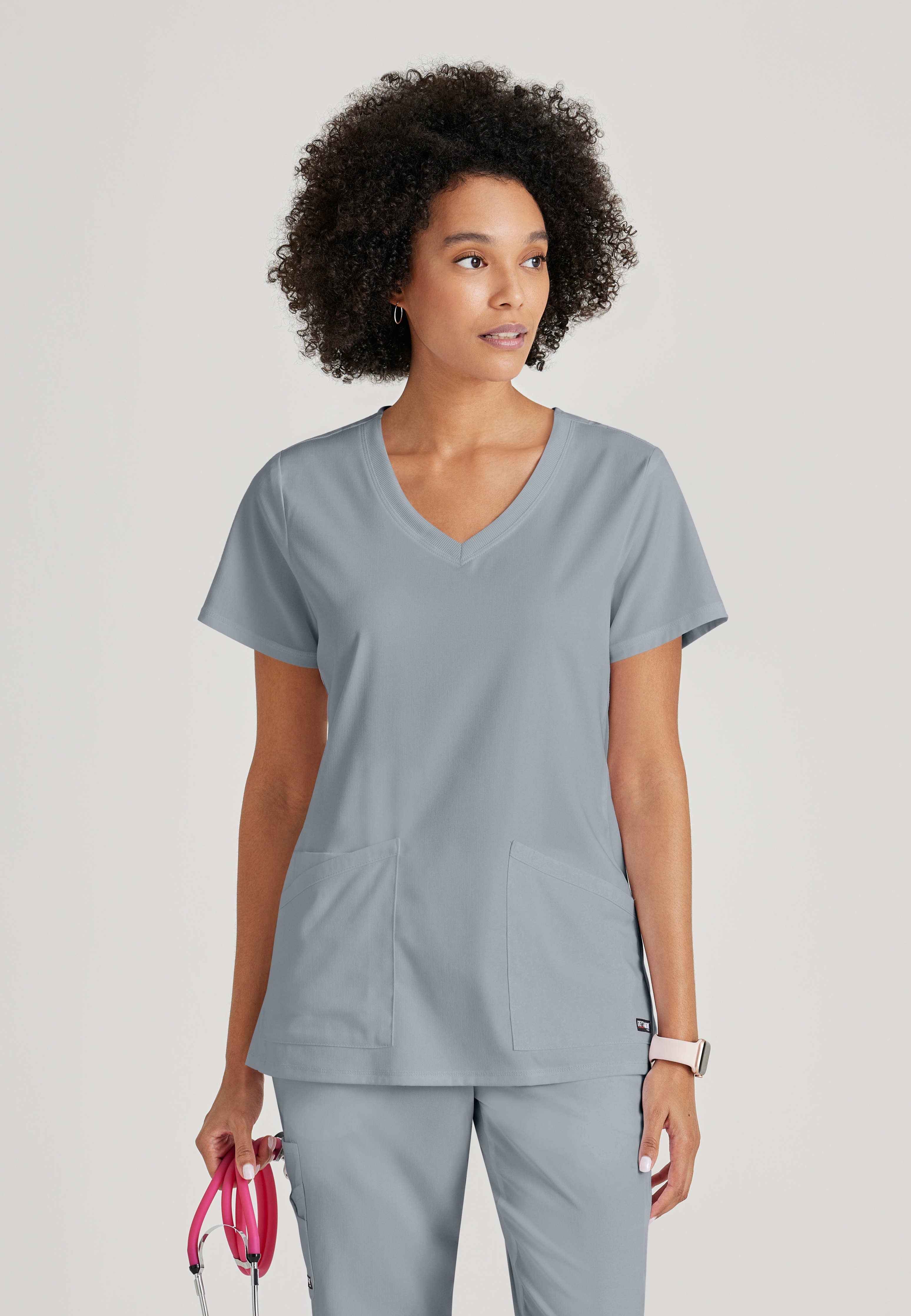 Front View of the Serena 3-Pocket Curved V-Neck Scrub Top in Moonstruck from Grey's Anatomy™ by Barco Spandex Stretch