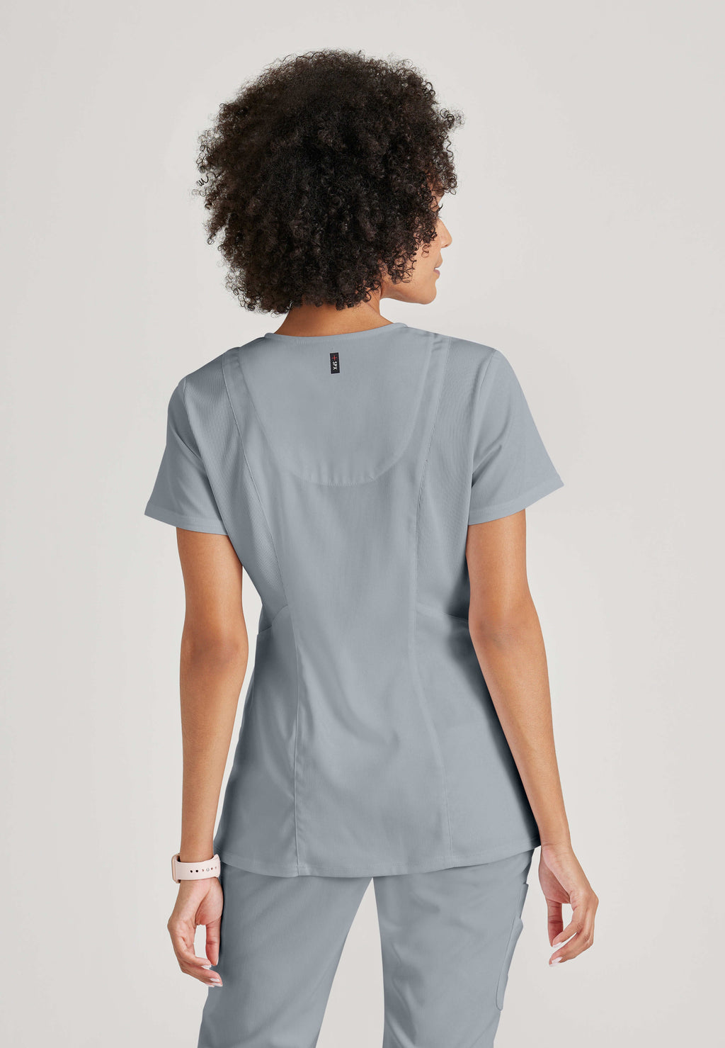 Full Body View of the Serena 3-Pocket Curved V-Neck Scrub Top in Moonstruck from Grey's Anatomy™ by Barco Spandex Stretch