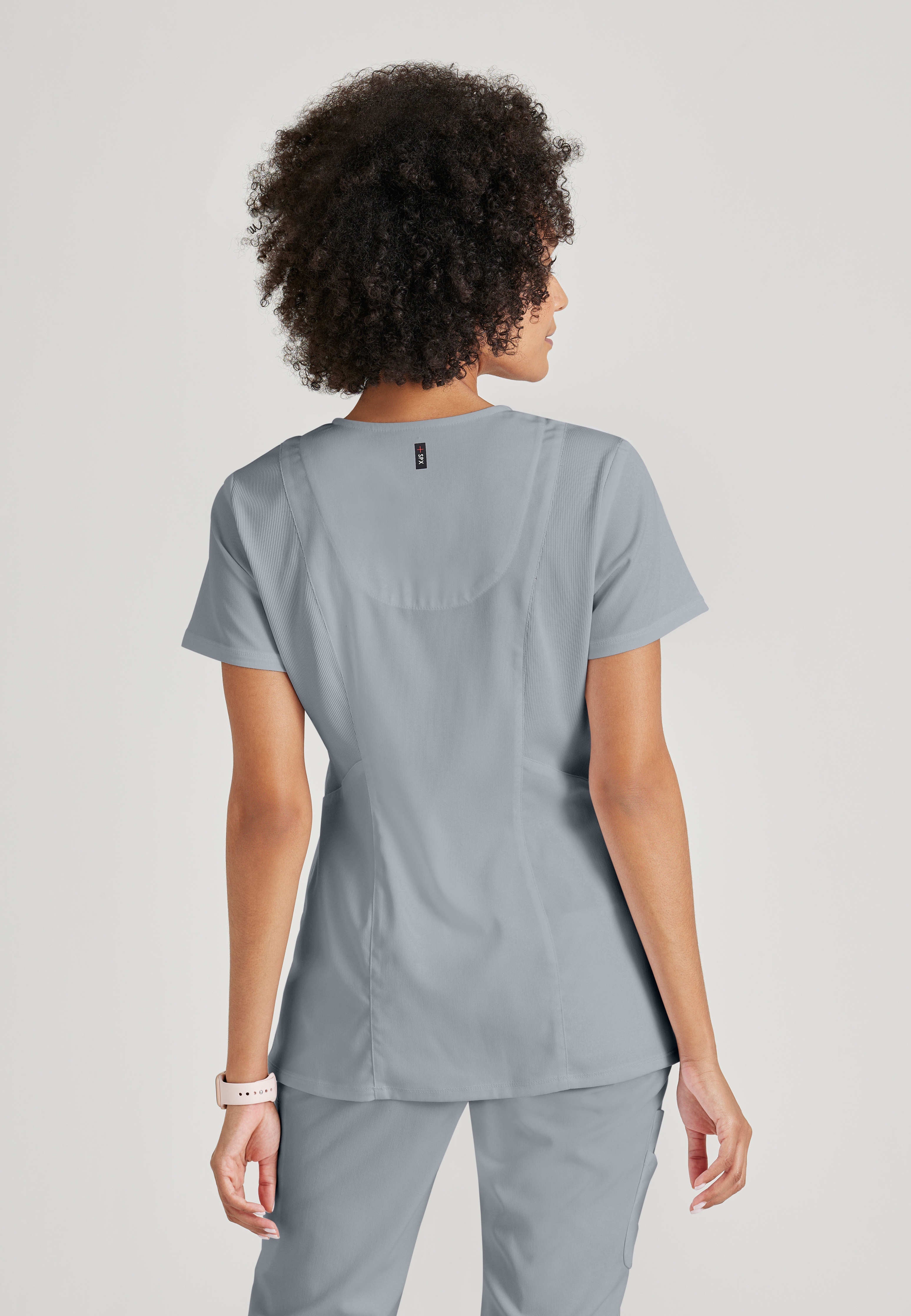 Full Body View of the Serena 3-Pocket Curved V-Neck Scrub Top in Moonstruck from Grey's Anatomy™ by Barco Spandex Stretch