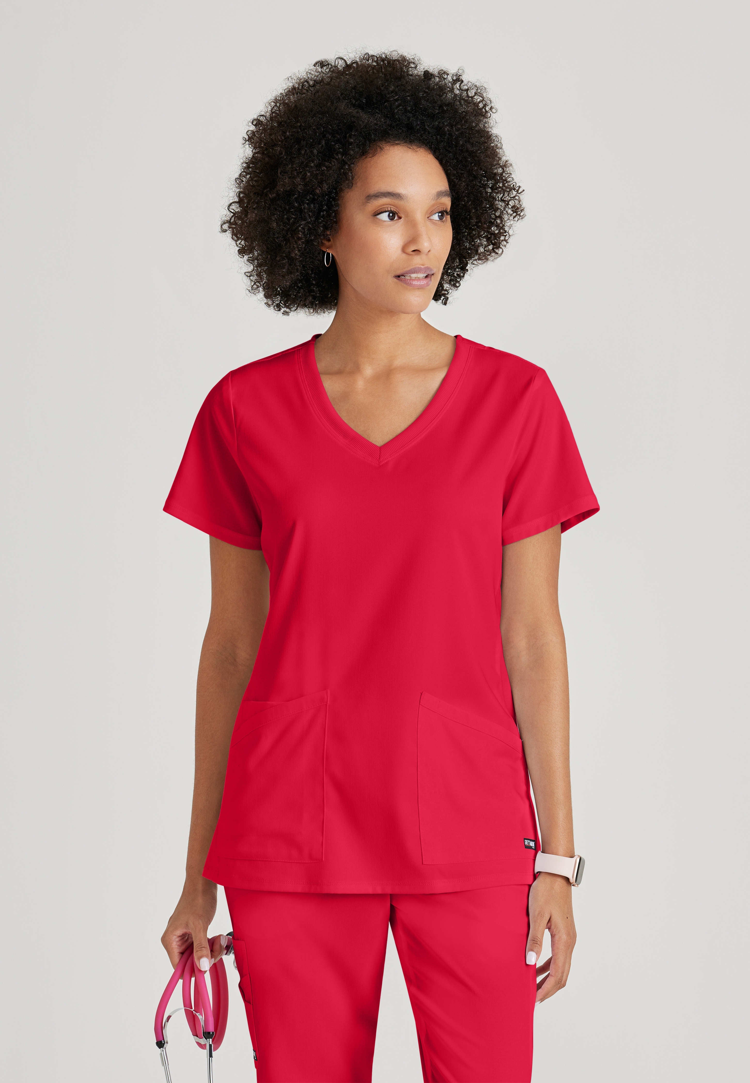 Front View of the Serena 3-Pocket Curved V-Neck Scrub Top in Scarlet Red from Grey's Anatomy™ by Barco Spandex Stretch