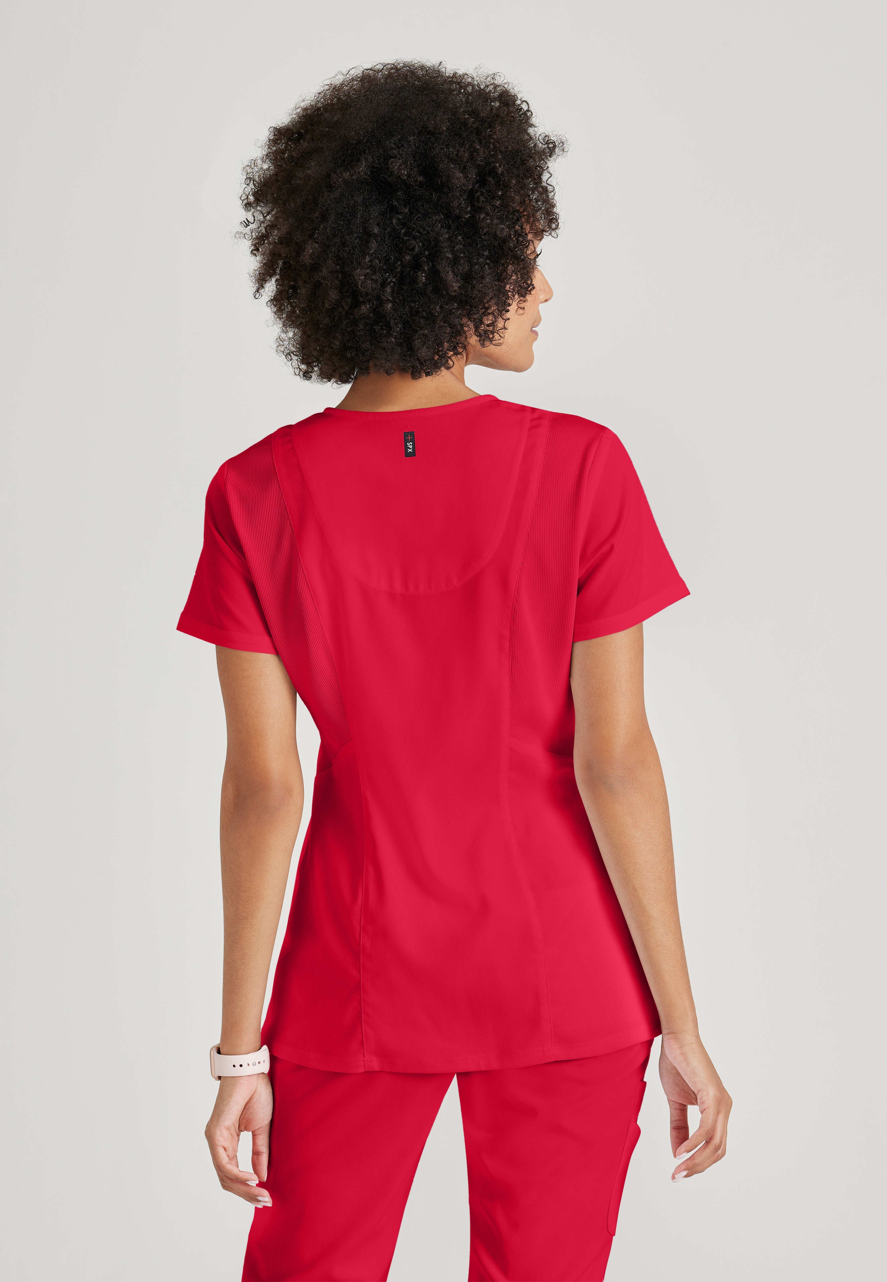 Full Body View of the Serena 3-Pocket Curved V-Neck Scrub Top in Scarlet Red from Grey's Anatomy™ by Barco Spandex Stretch
