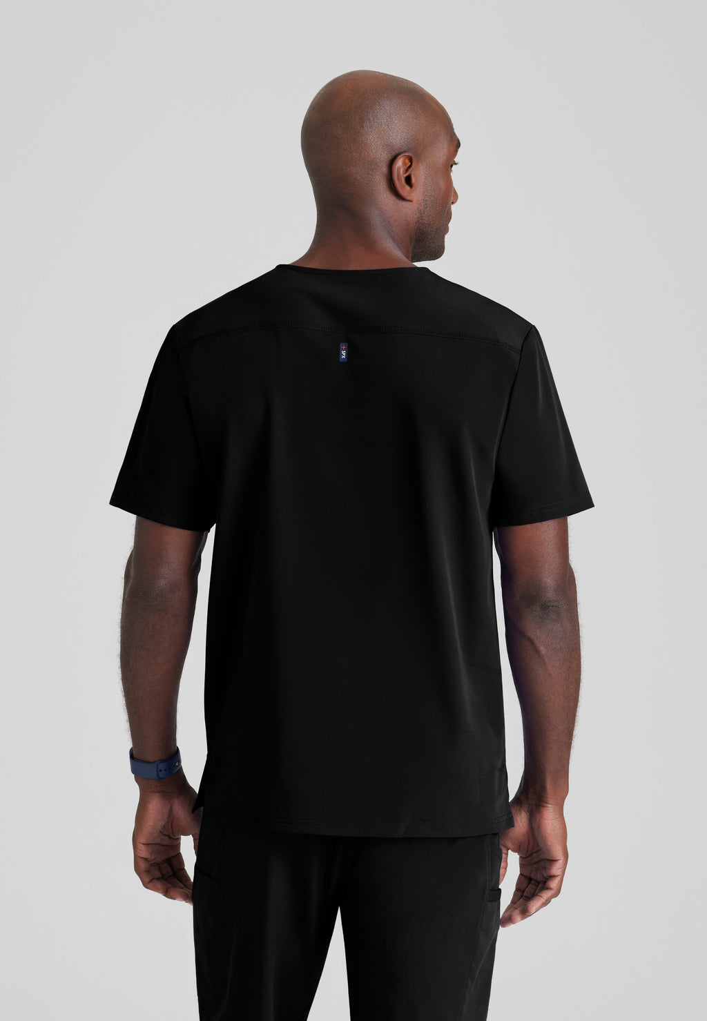 Back View of the Murphy 2-Pocket V-Neck Scrub Top in Black from Grey's Anatomy™ by Barco Spandex Stretch