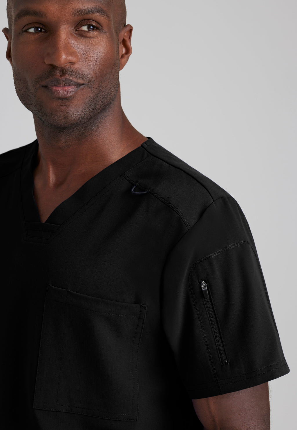 Detail Shot of the Murphy 2-Pocket V-Neck Scrub Top in Black from Grey's Anatomy™ by Barco Spandex Stretch