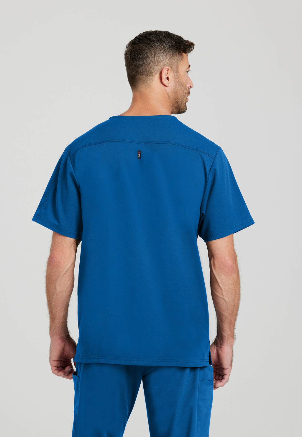 Back View of the Murphy 2-Pocket V-Neck Scrub Top in New Royal from Grey's Anatomy™ by Barco Spandex Stretch