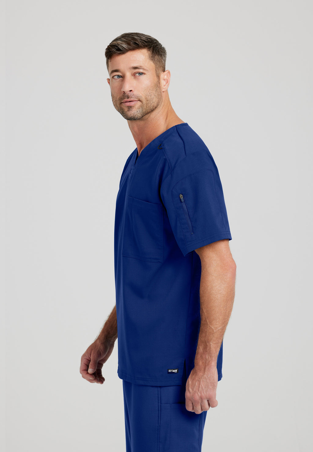 Side View of the Murphy 2-Pocket V-Neck Scrub Top in Indigo from Grey's Anatomy™ by Barco Spandex Stretch
