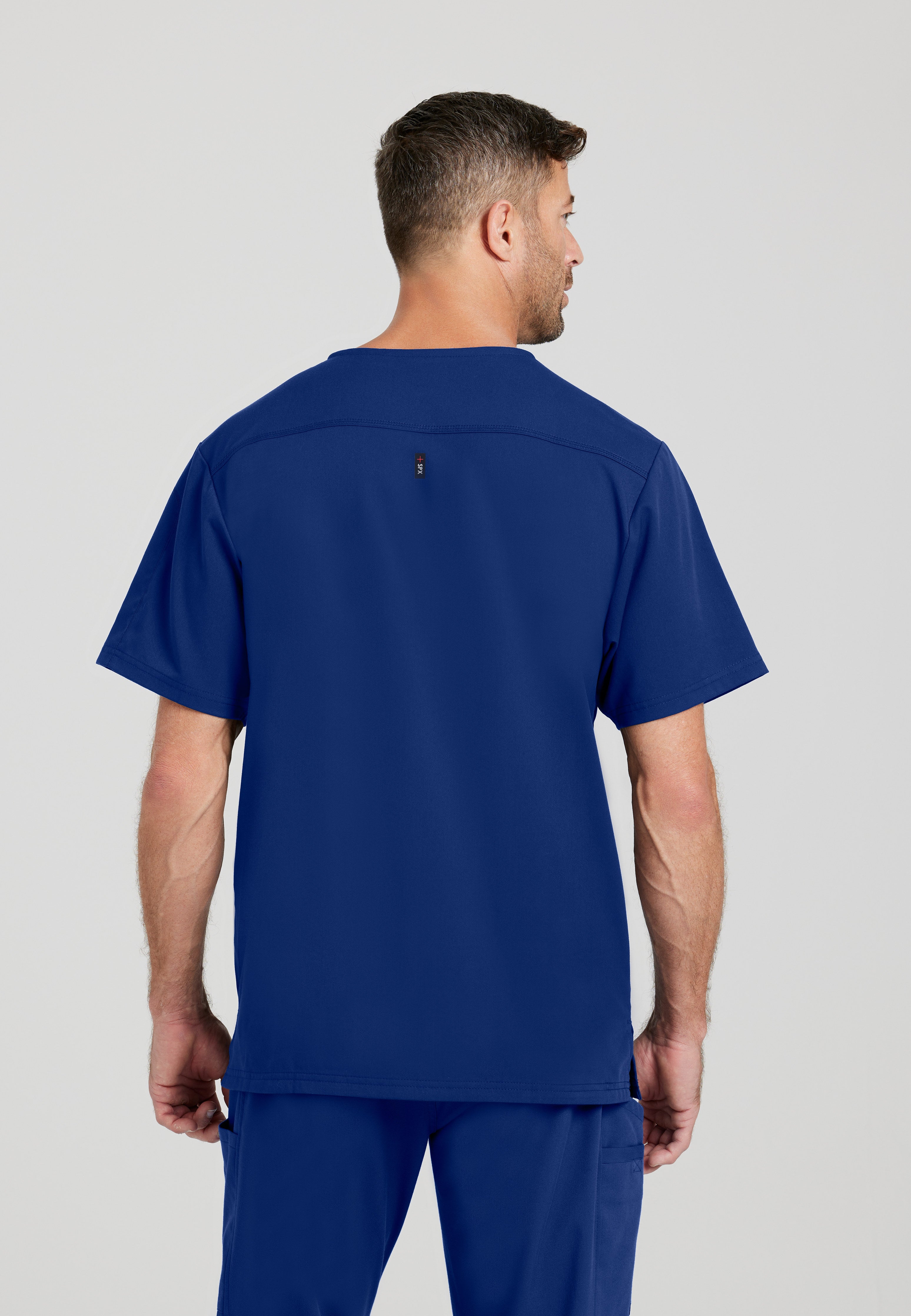 Back View of the Murphy 2-Pocket V-Neck Scrub Top in Indigo from Grey's Anatomy™ by Barco Spandex Stretch