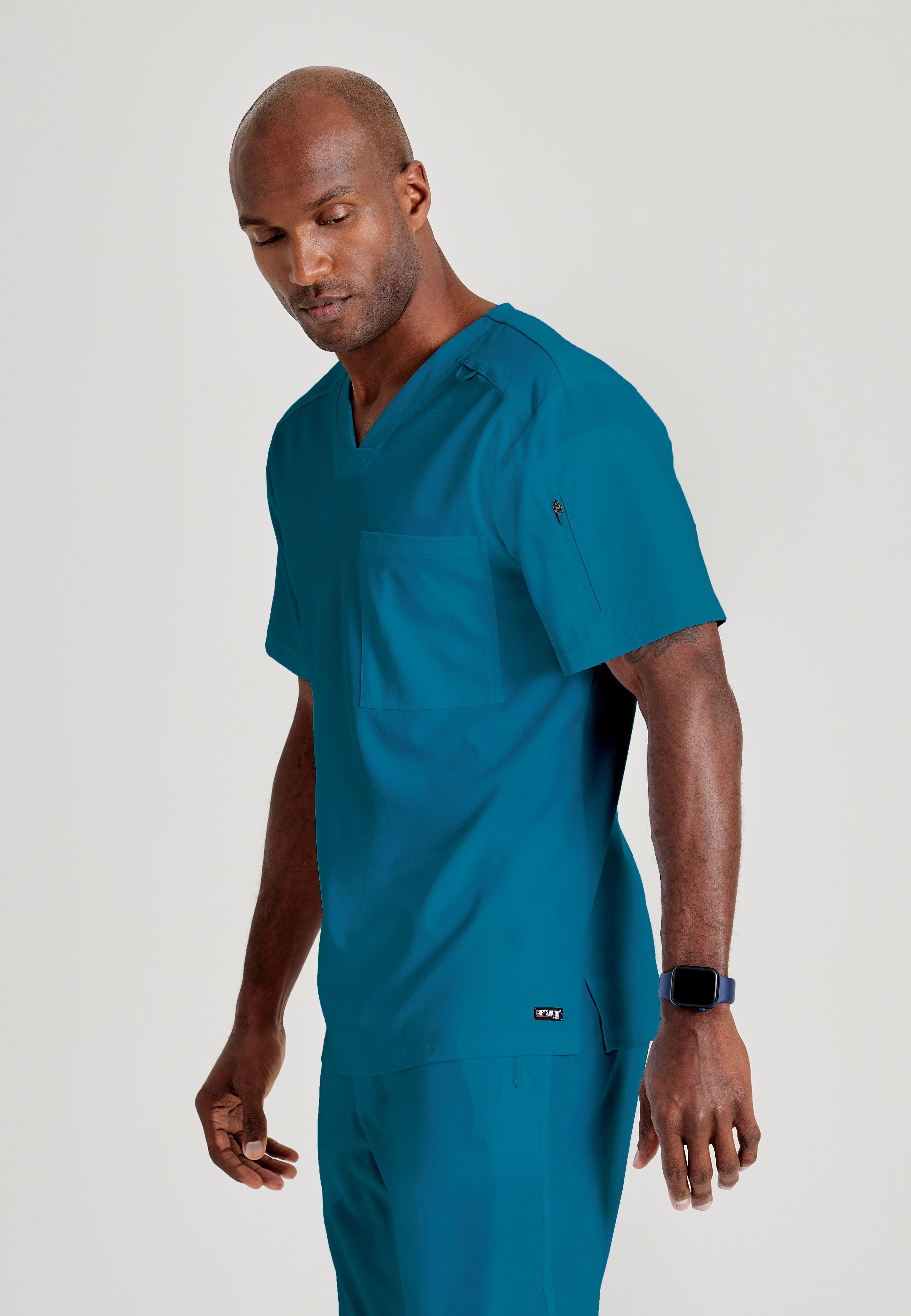 Grey's Anatomy Spandex-Stretch Men’s Bahama Chest Pocket V-Neck Scrub Top. Bungee loop. Soft stretch fabric wicks moisture. 