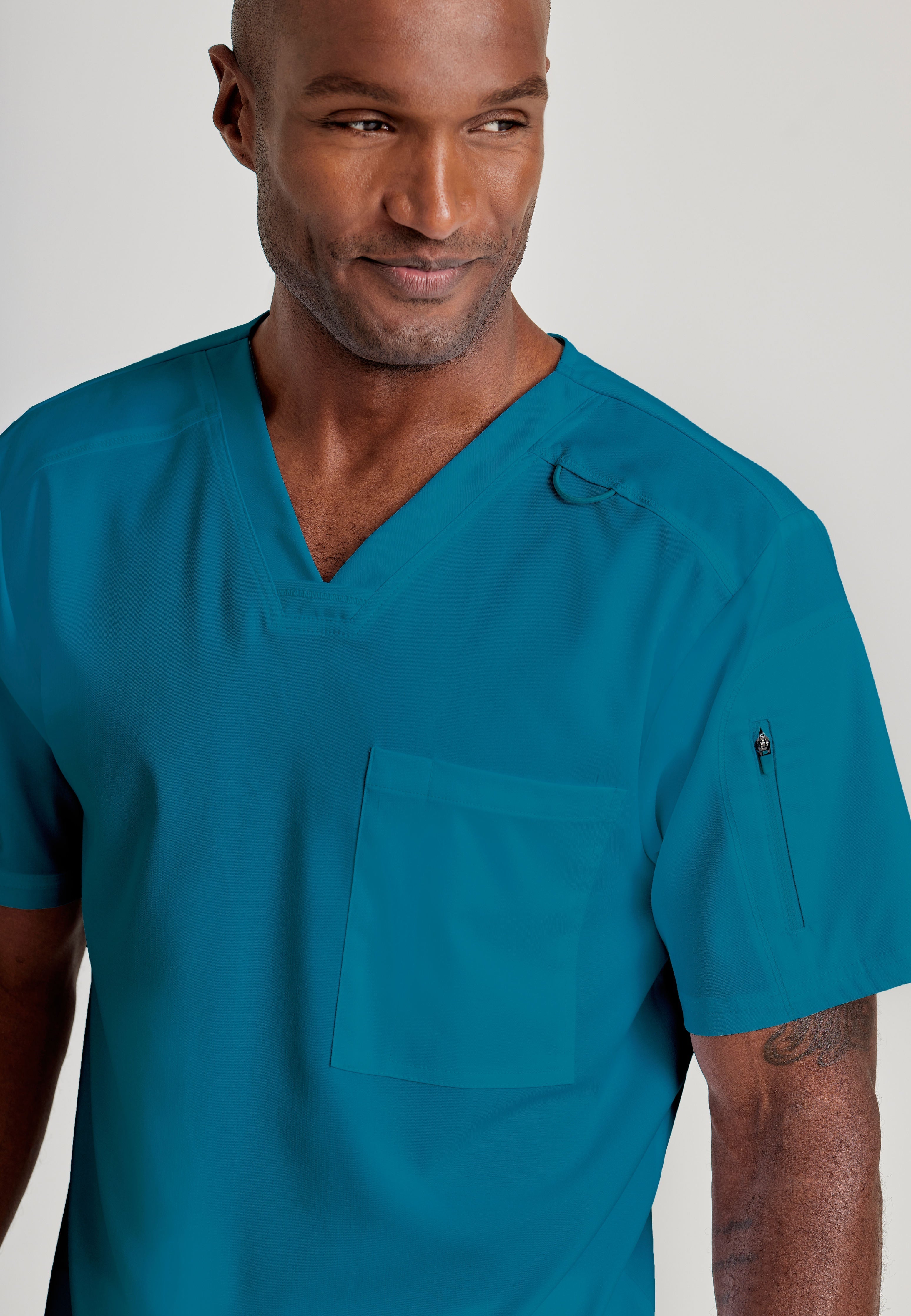 Grey's Anatomy Spandex-Stretch Men’s Bahama Chest Pocket V-Neck Scrub Top. Bungee loop. Soft stretch fabric wicks moisture. 