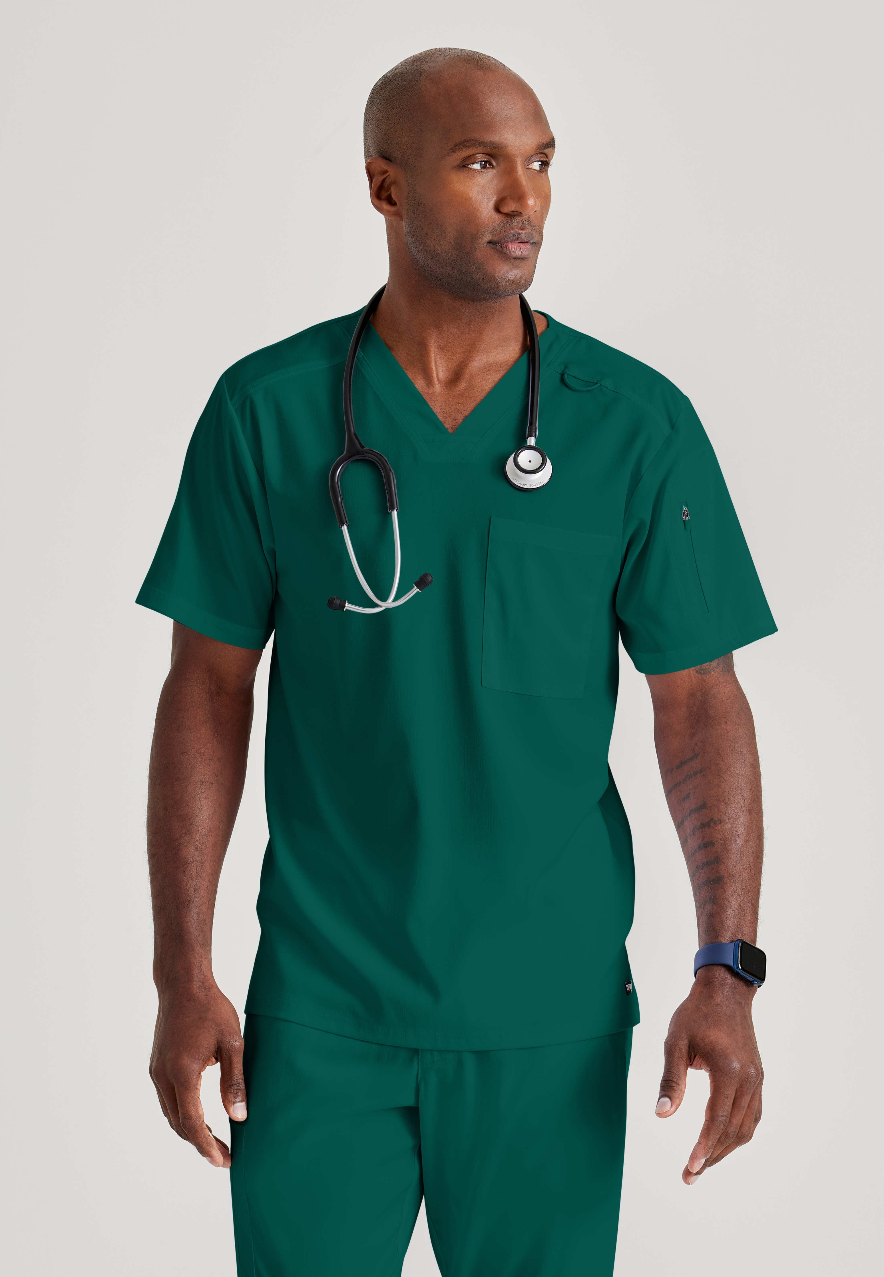 Grey's Anatomy Spandex-Stretch Men’s hunter green Chest Pocket V-Neck Scrub Top. Bungee loop. Soft stretch fabric wicks moisture. 