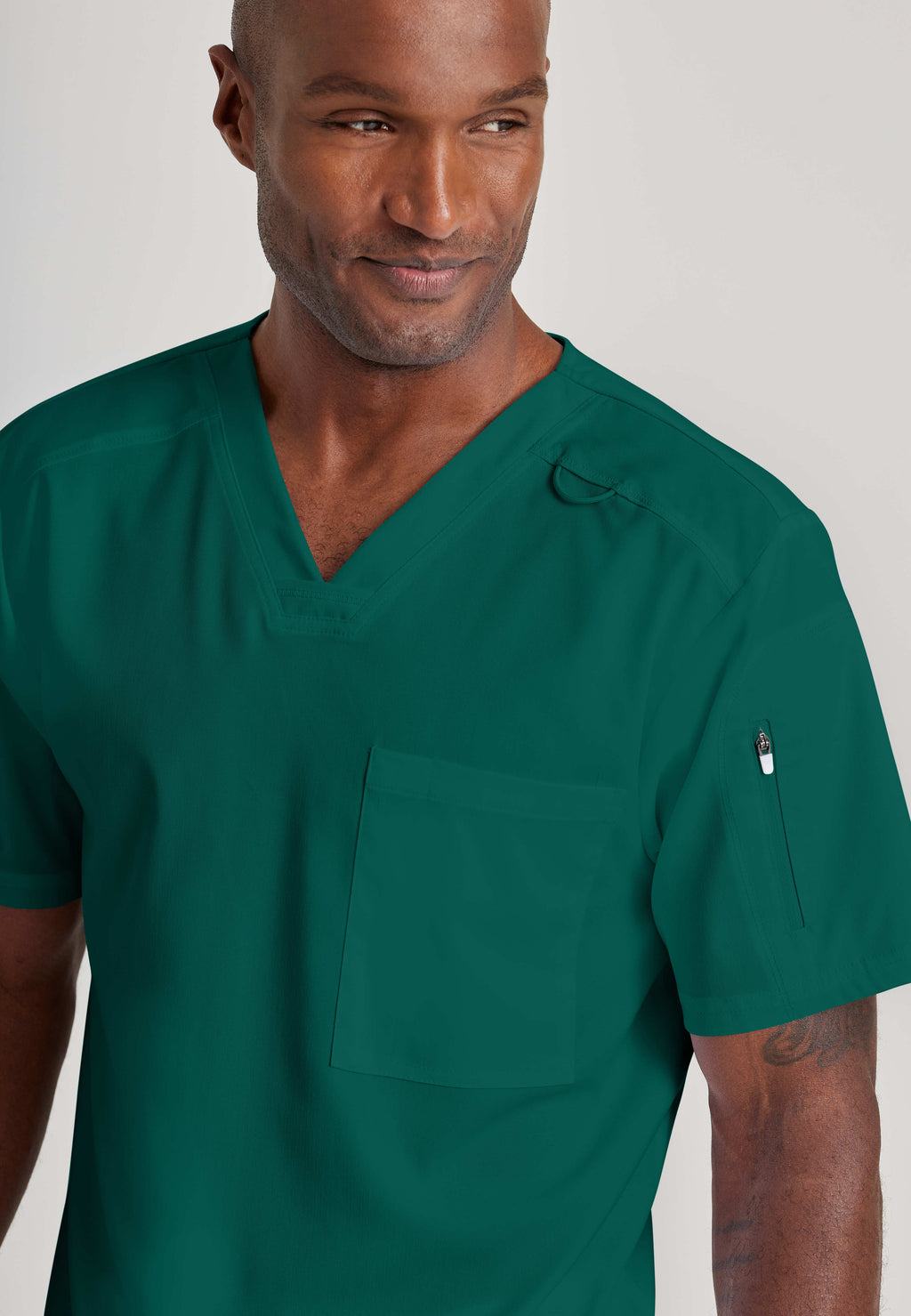 Grey's Anatomy Spandex-Stretch Men’s hunter green Chest Pocket V-Neck Scrub Top. Bungee loop. Soft stretch fabric wicks moisture. 