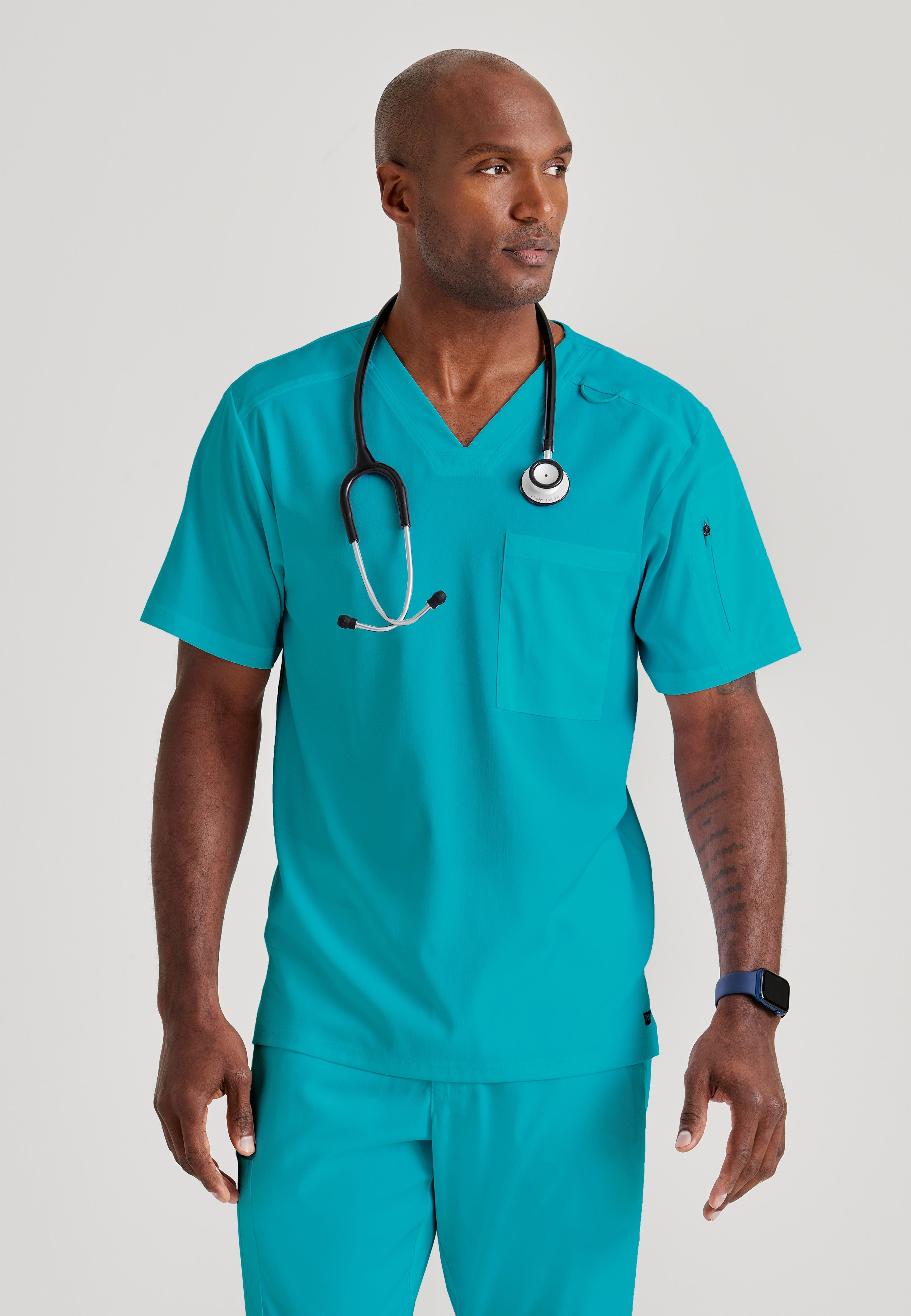 Grey's Anatomy Spandex-Stretch Men’s teal Chest Pocket V-Neck Scrub Top. Bungee loop. Soft stretch fabric wicks moisture. 