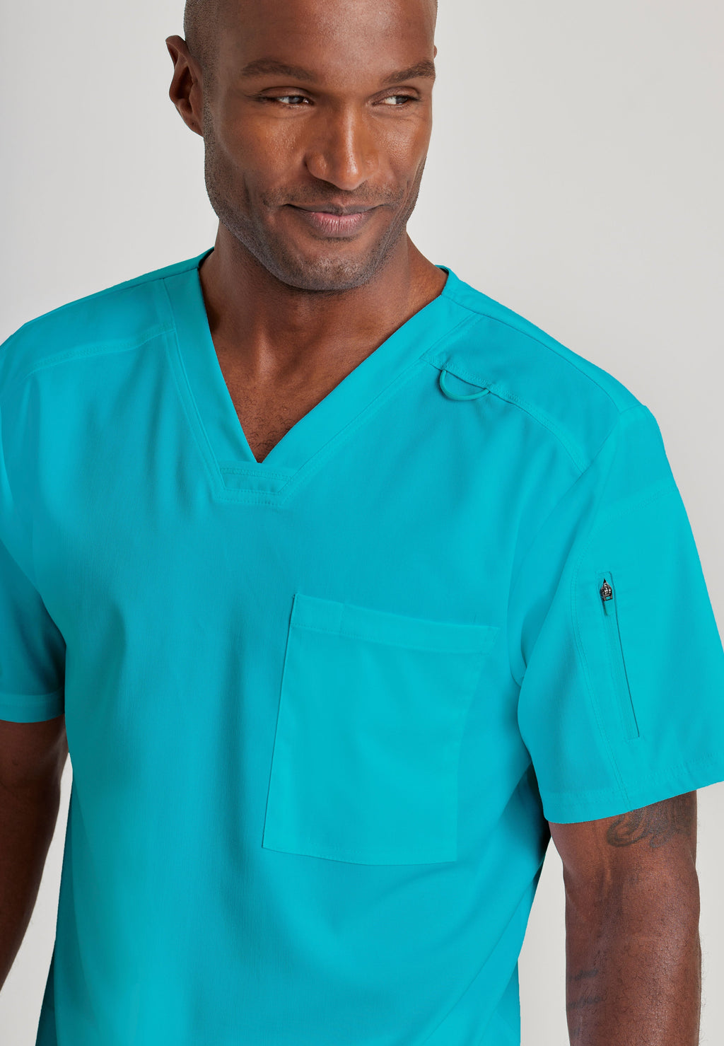 Grey's Anatomy Spandex-Stretch Men’s teal Chest Pocket V-Neck Scrub Top. Bungee loop. Soft stretch fabric wicks moisture. 