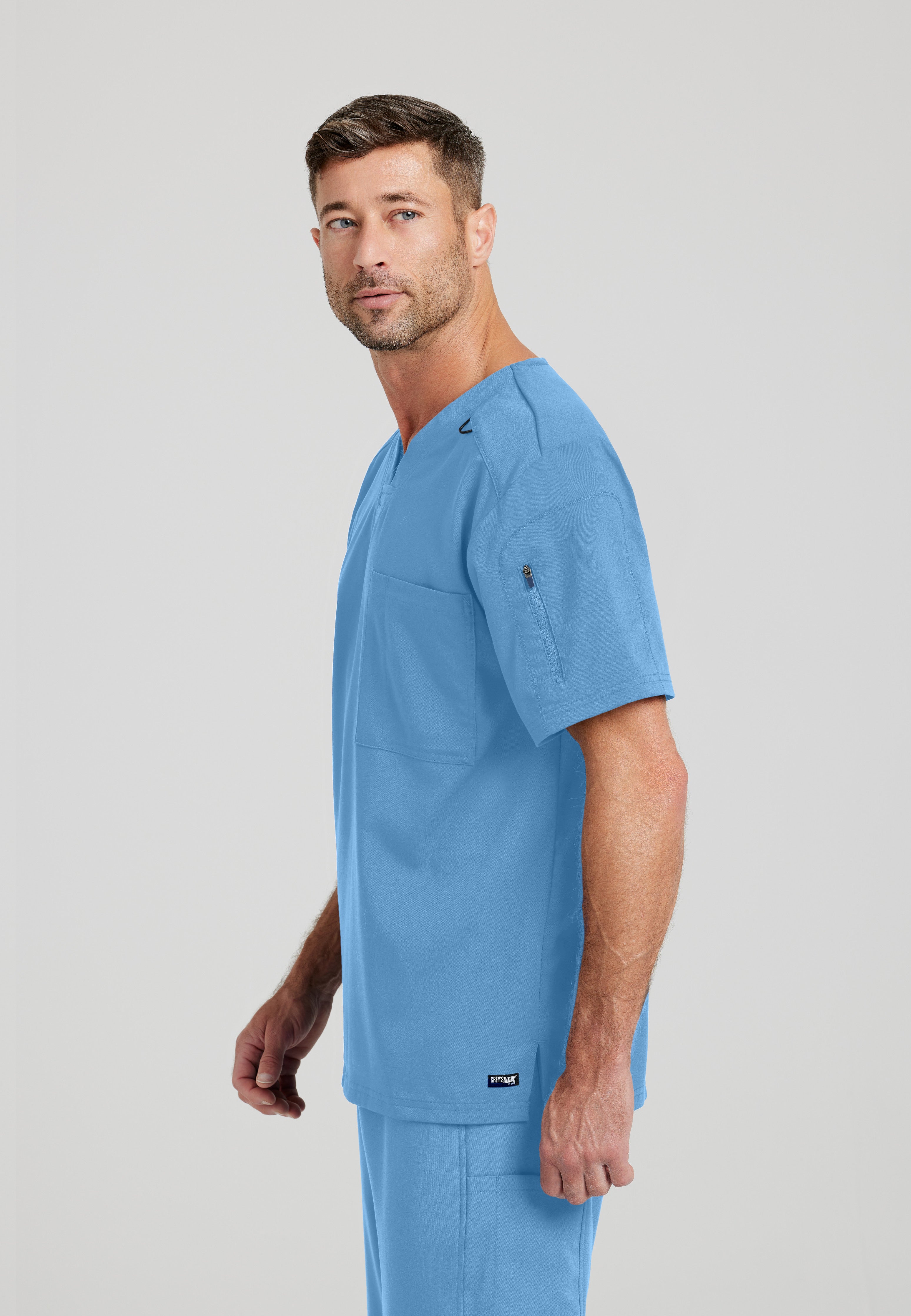 Side View of the Murphy 2-Pocket V-Neck Scrub Top in Ciel Blue from Grey's Anatomy™ by Barco Spandex Stretch