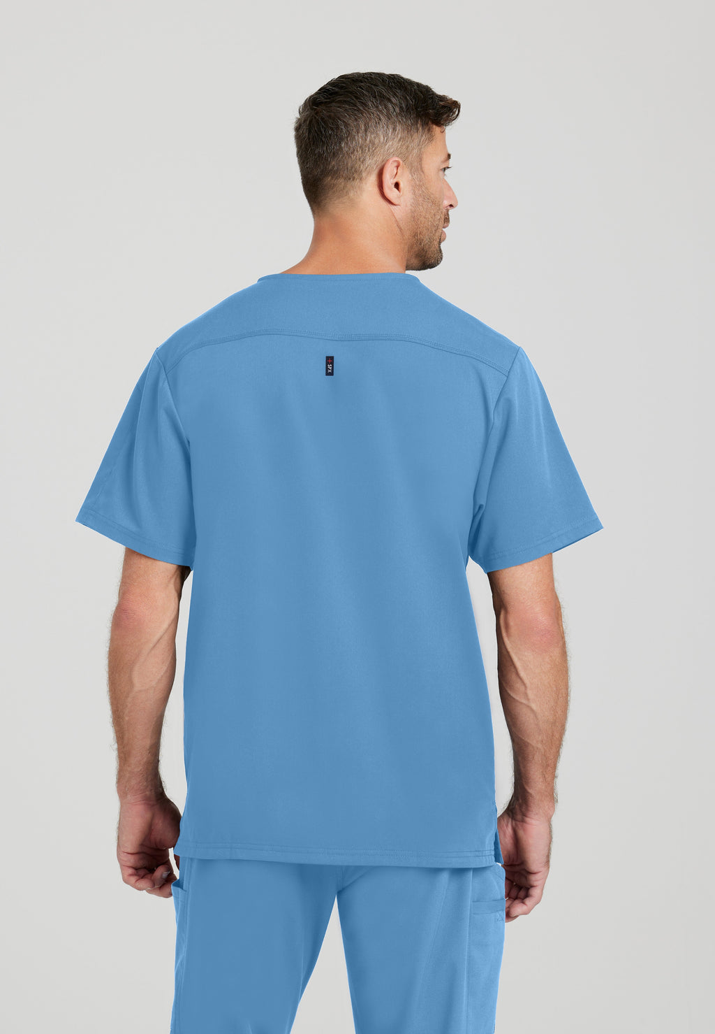 Back View of the Murphy 2-Pocket V-Neck Scrub Top in Ciel Blue from Grey's Anatomy™ by Barco Spandex Stretch