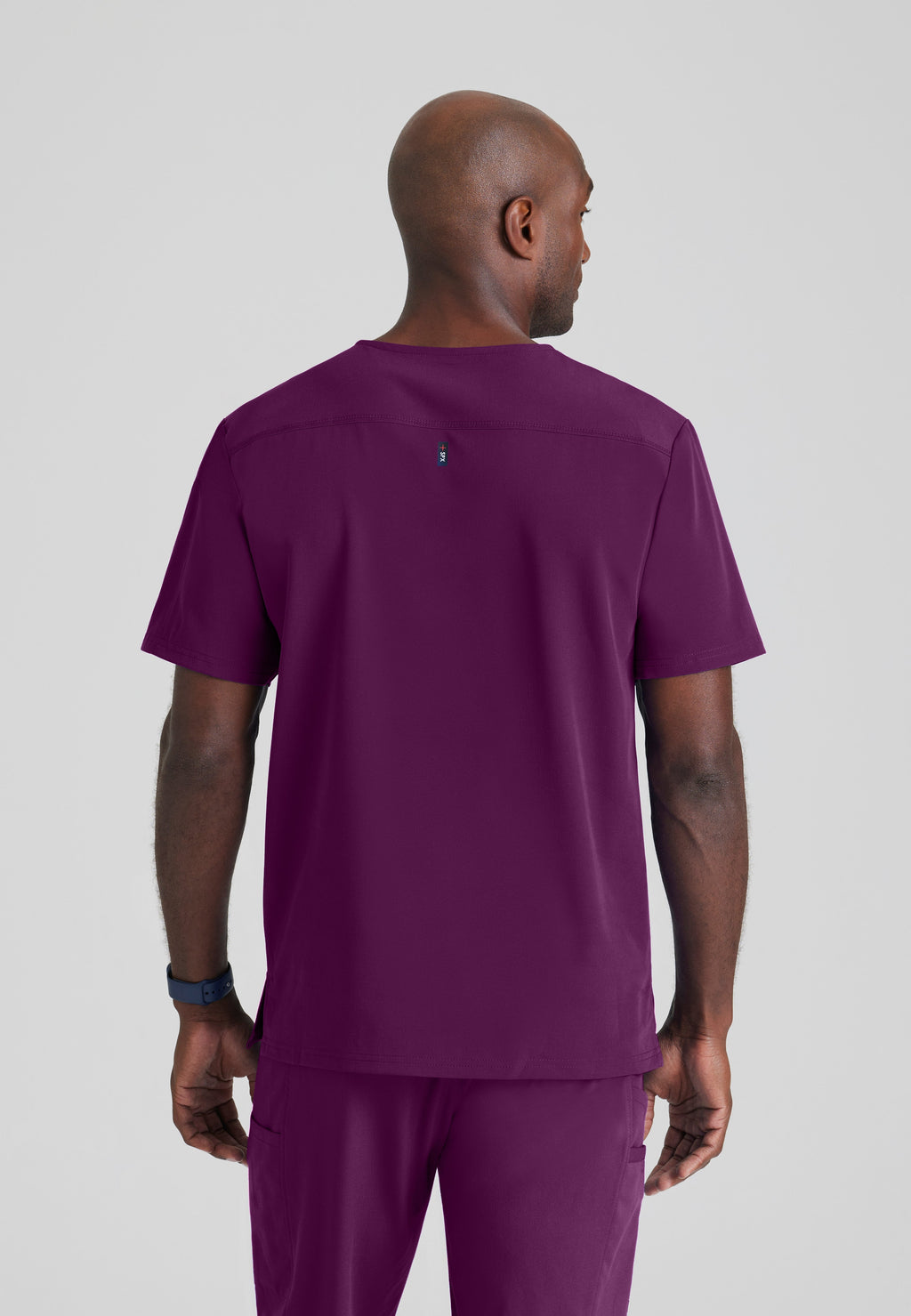 Back View of the Murphy 2-Pocket V-Neck Scrub Top in Wine from Grey's Anatomy™ by Barco Spandex Stretch