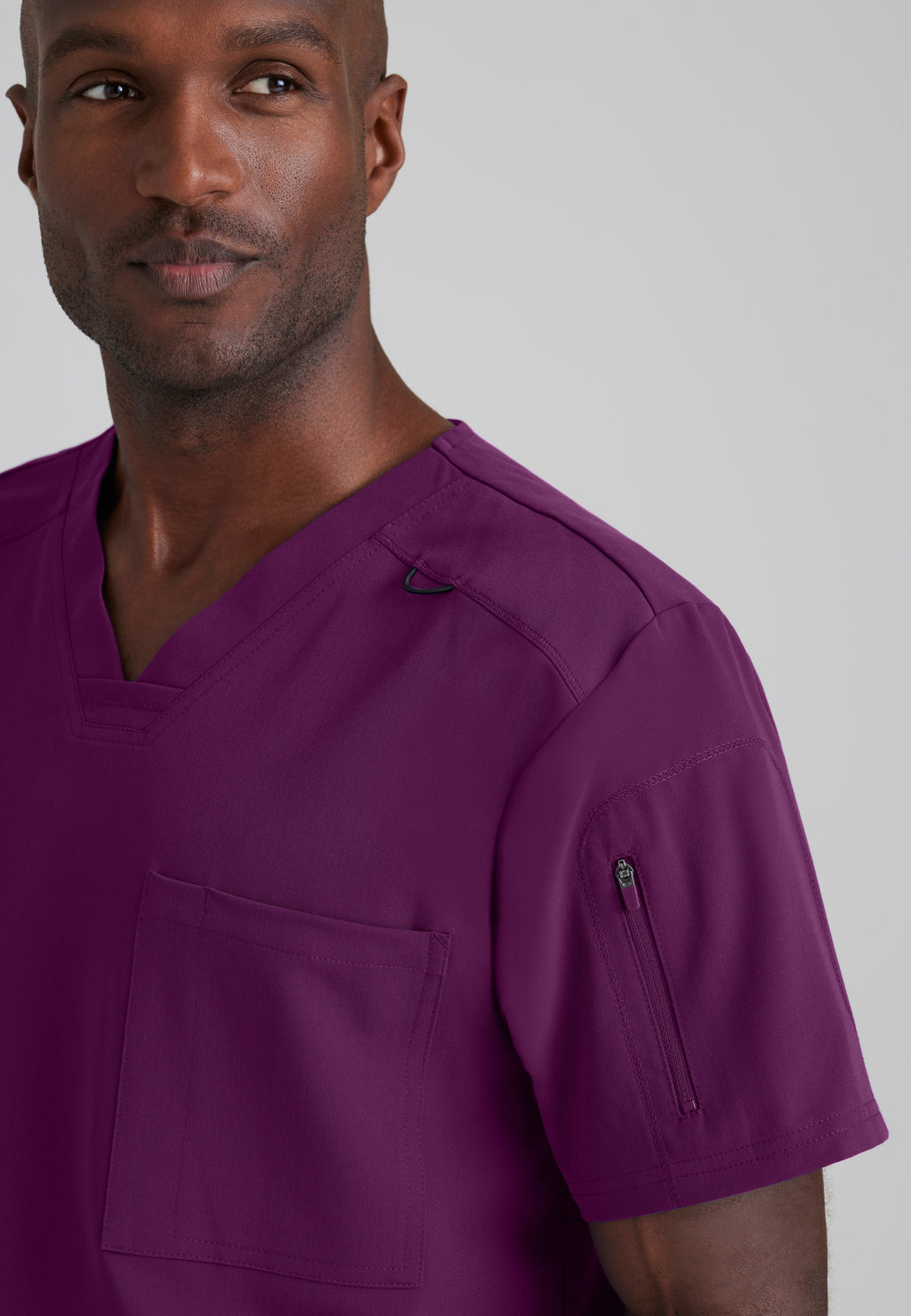 Detail Shot of the Murphy 2-Pocket V-Neck Scrub Top in Wine from Grey's Anatomy™ by Barco Spandex Stretch
