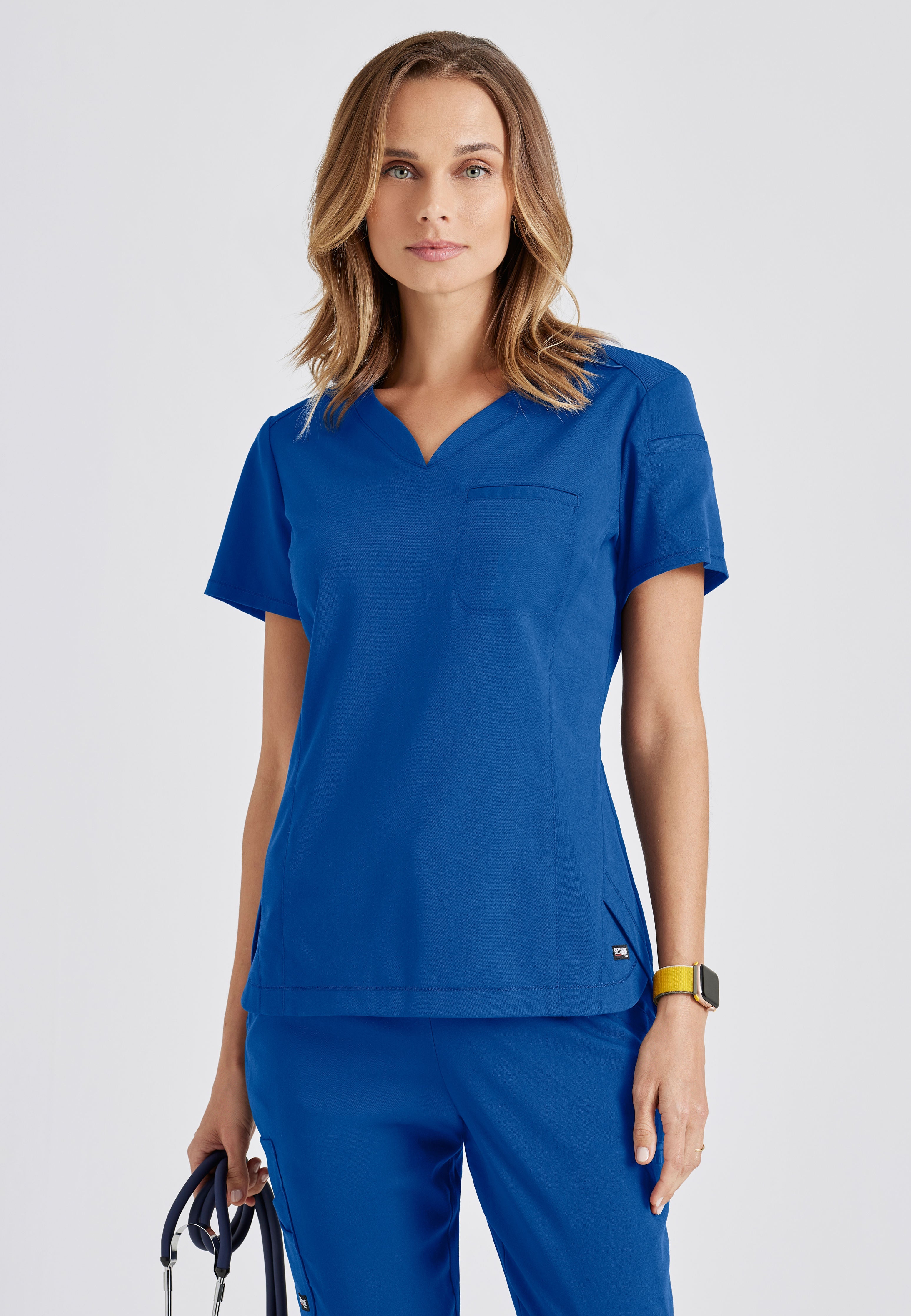 Front View of the Capri 2-Pocket Hourglass V-Neck Scrub Top in New Royal from Grey's Anatomy™ by Barco Spandex Stretch