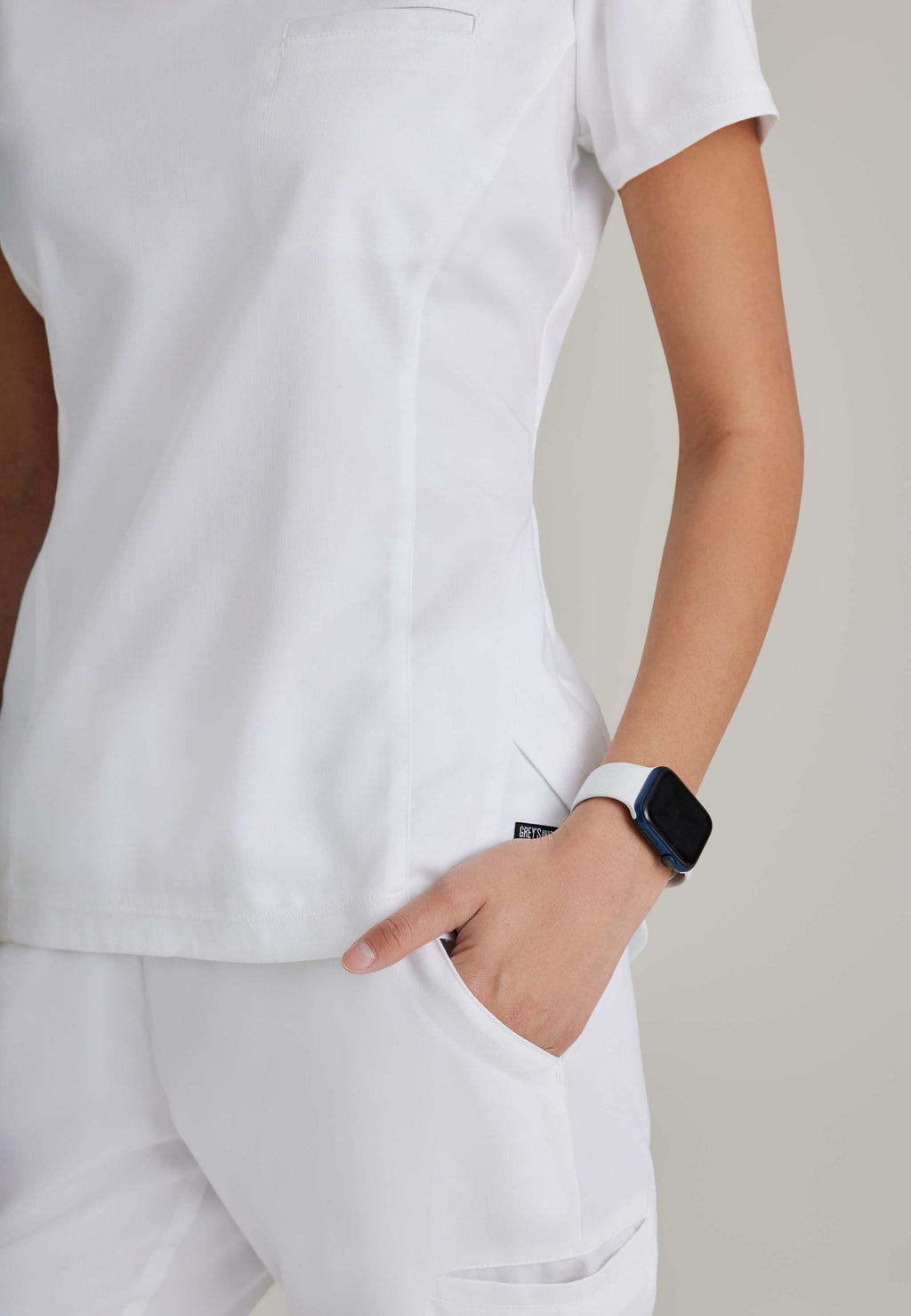 Back View of the Capri 2-Pocket Hourglass V-Neck Scrub Top in White from Grey's Anatomy™ by Barco Spandex Stretch