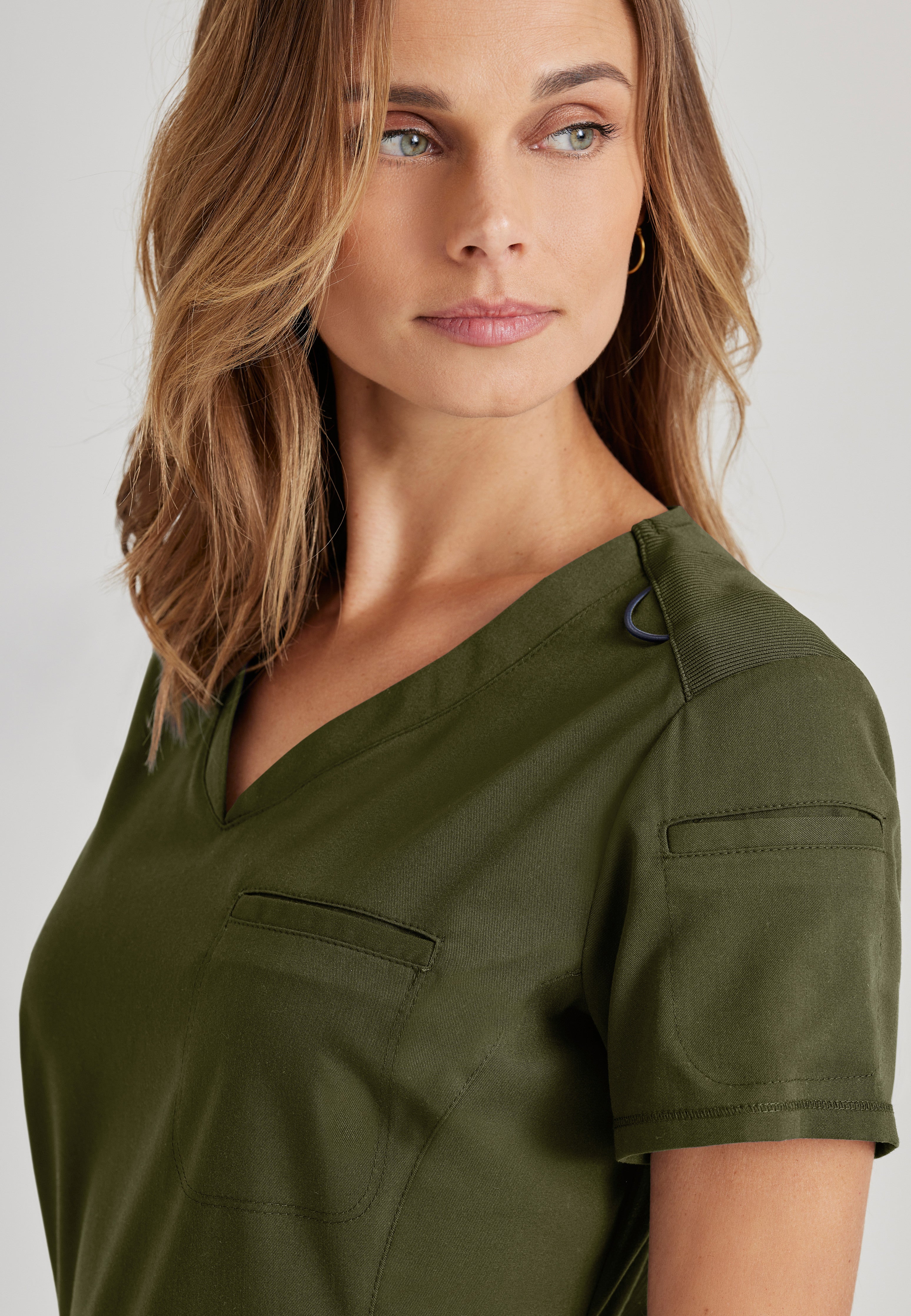 Detail Shot of the Capri Tuck-in Scrub Top in Olive from Grey's Anatomy™ by Barco Spandex Stretch
