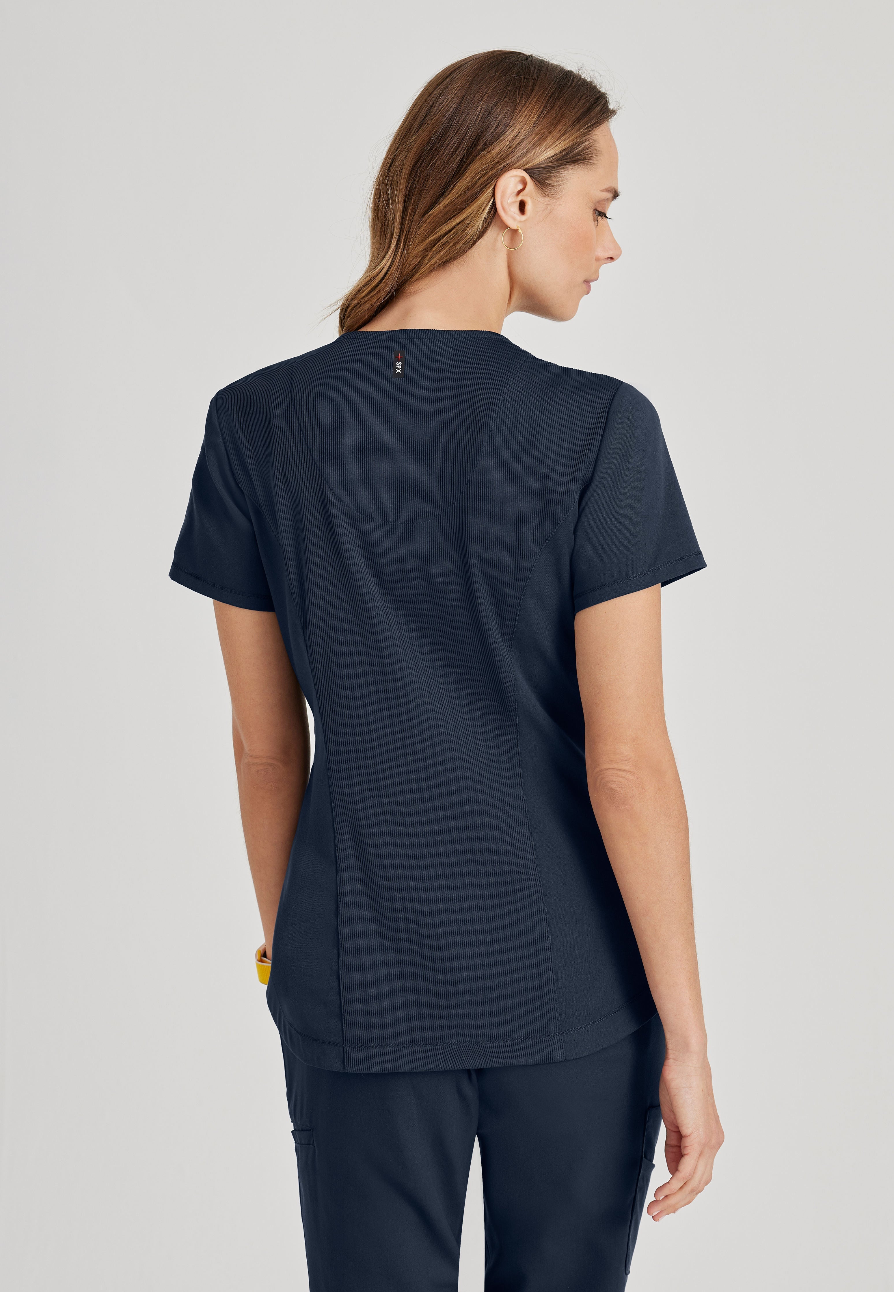 Back View of the Capri 2-Pocket Hourglass V-Neck Scrub Top in Steel from Grey's Anatomy™ by Barco Spandex Stretch