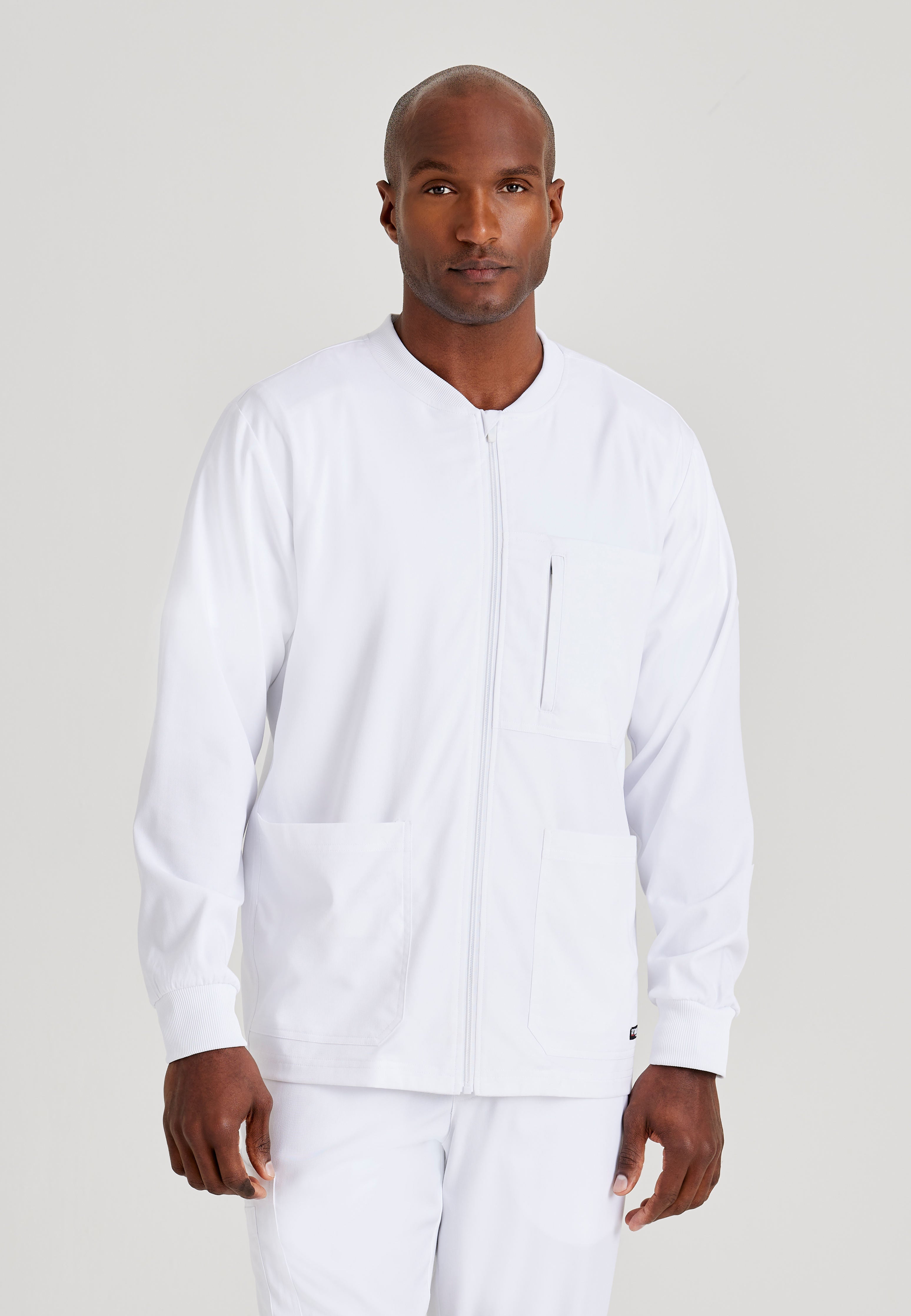 Grey's Anatomy Spandex-Stretch Men’s white Warm-Up Scrub Jacket. Zip front with chin guard. Ribbed sleeve cuffs. 