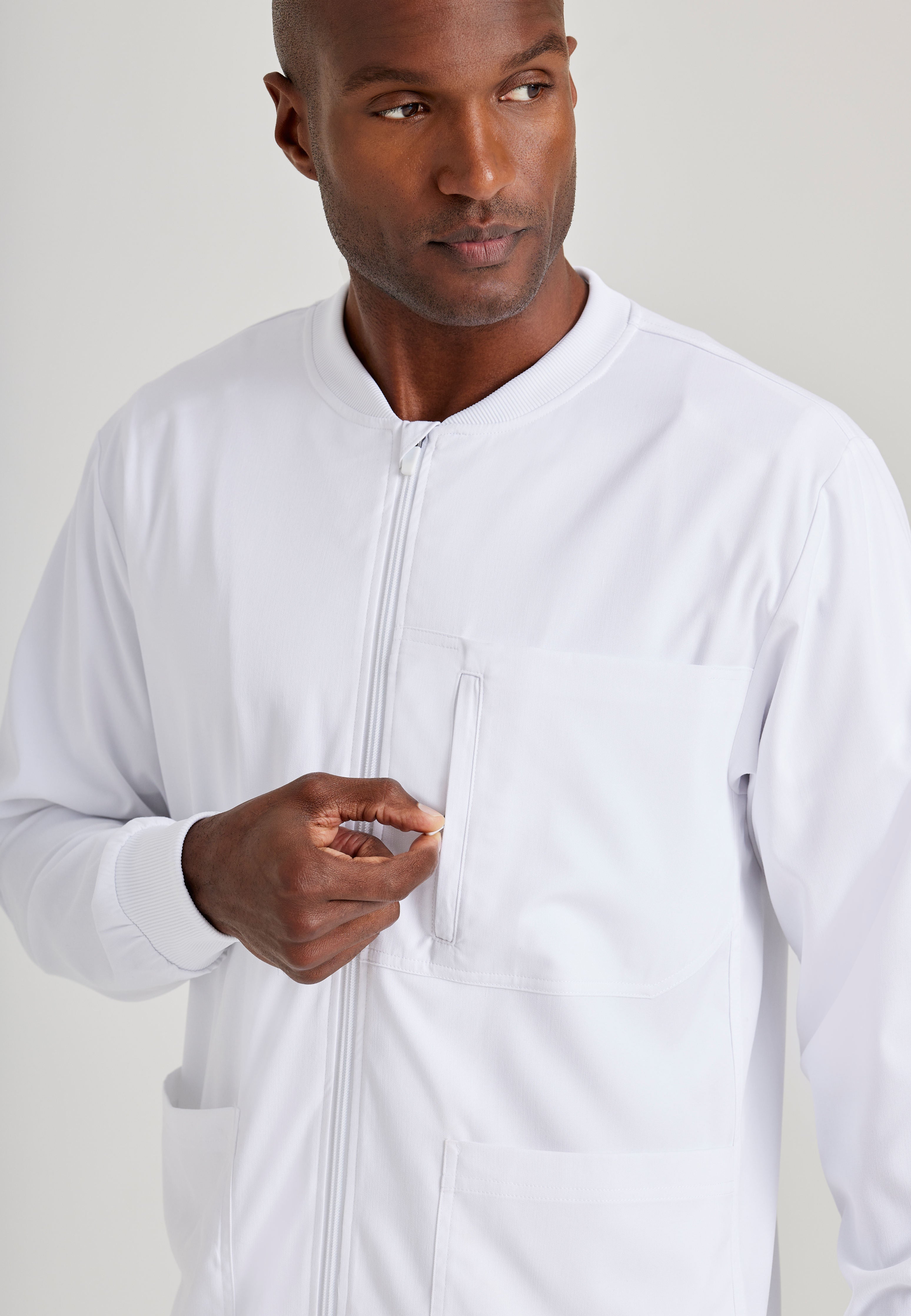 Grey's Anatomy Spandex-Stretch Men’s white Warm-Up Scrub Jacket. Zip front with chin guard. Ribbed sleeve cuffs. 