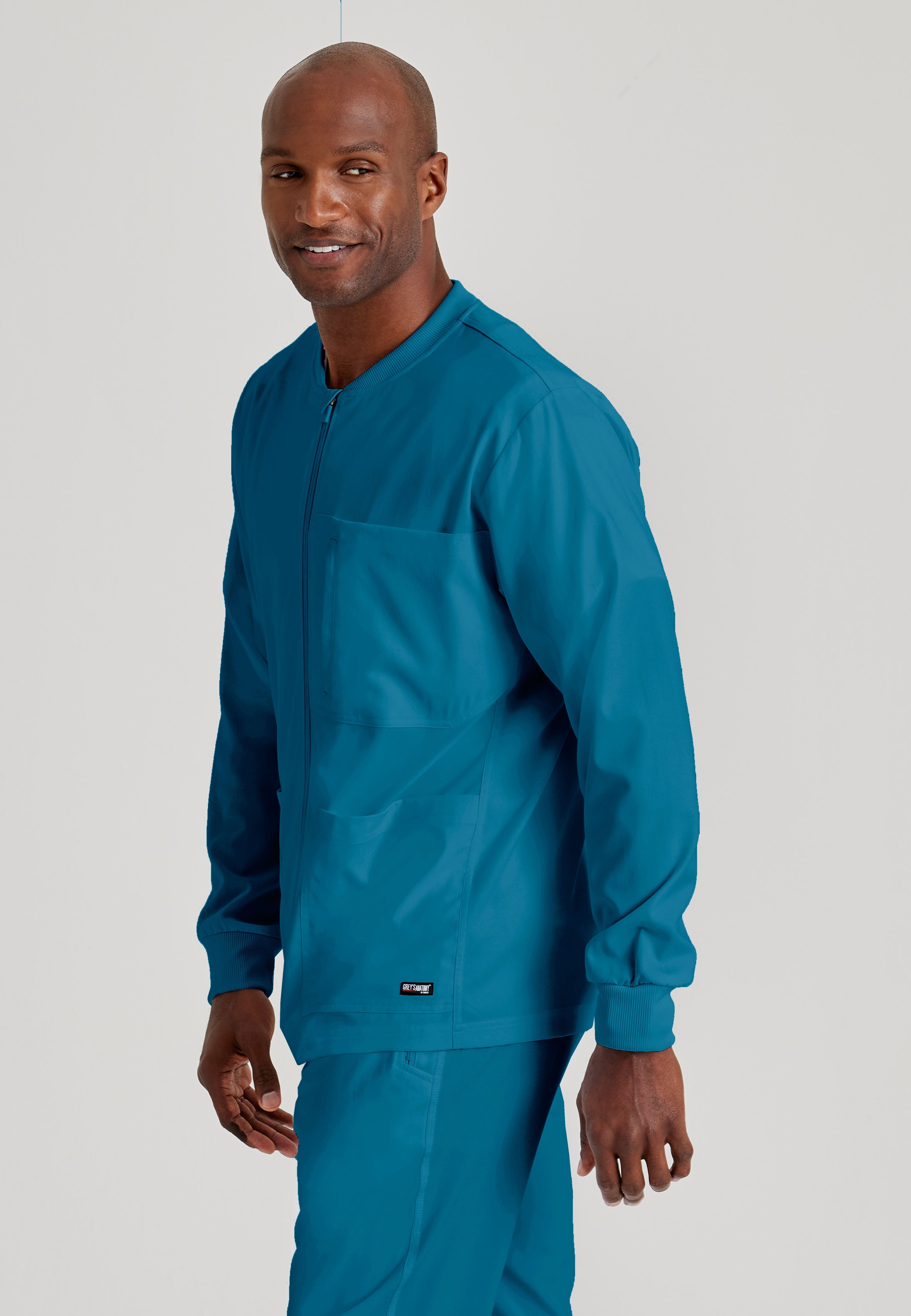 Grey's Anatomy Spandex-Stretch Men’s Bahama Warm-Up Scrub Jacket. Zip front with chin guard. Ribbed sleeve cuffs. 